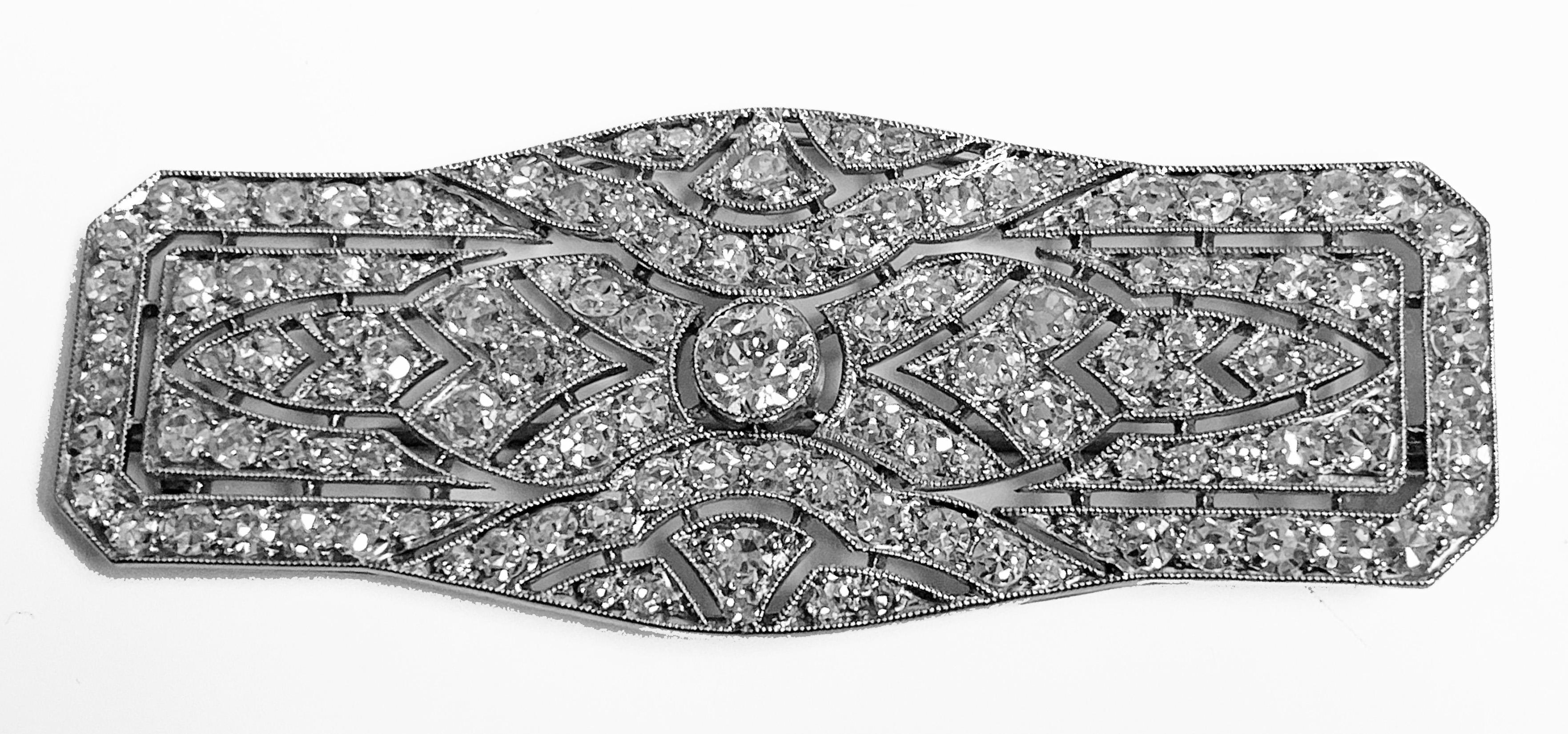Art Deco French Diamond Platinum plaque Brooch, C.1910. The Brooch of rectangular shape with chamfered corners, milligrain set in the centre with an old european cut diamond approximately 0.40 ct. The surround mount of open pierced milligrain design