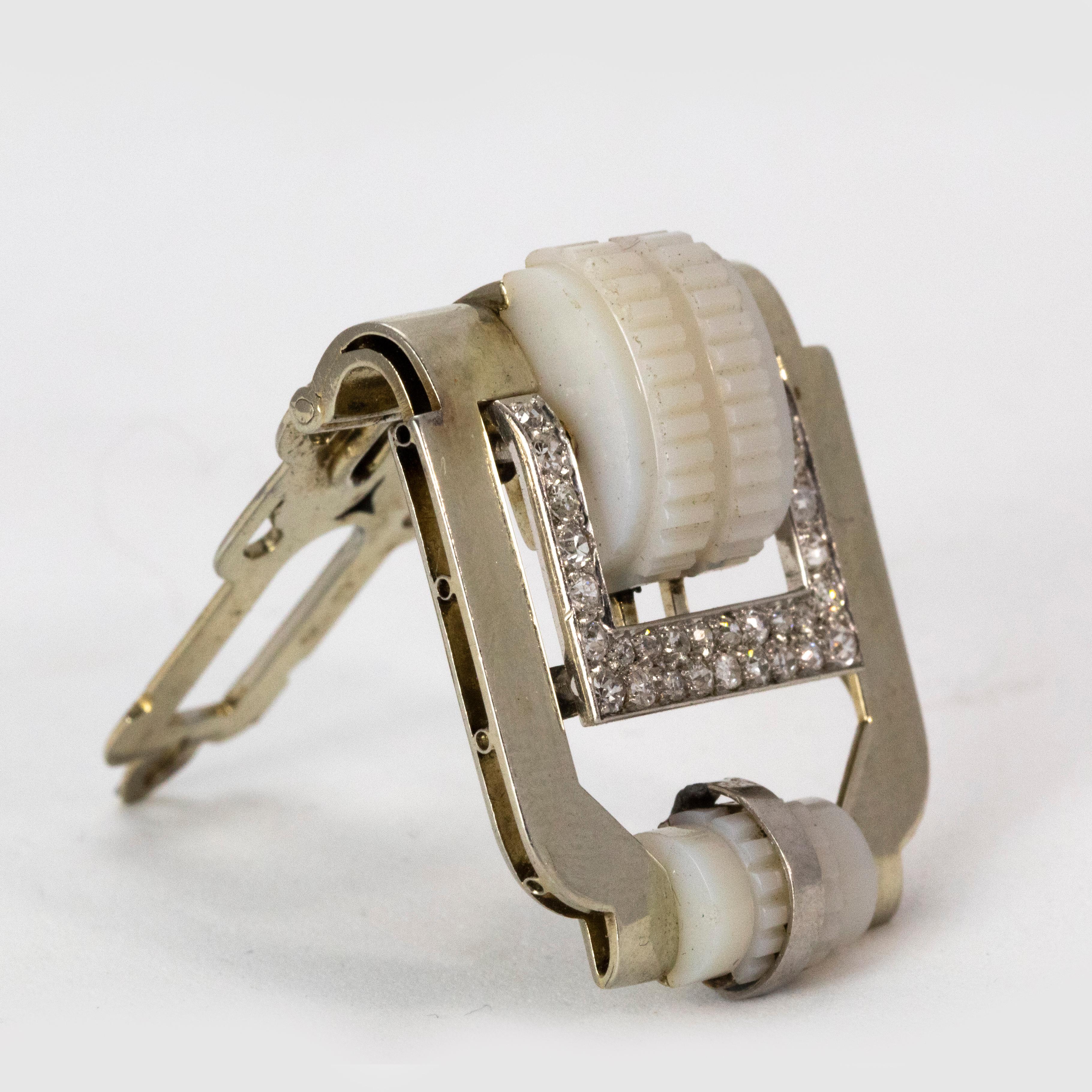 An exquisite diamond encrusted dress clip, modelled in platinum and chalcedony. This beautiful clip was masterfully crafted in France during the Art Deco era circa 1920.