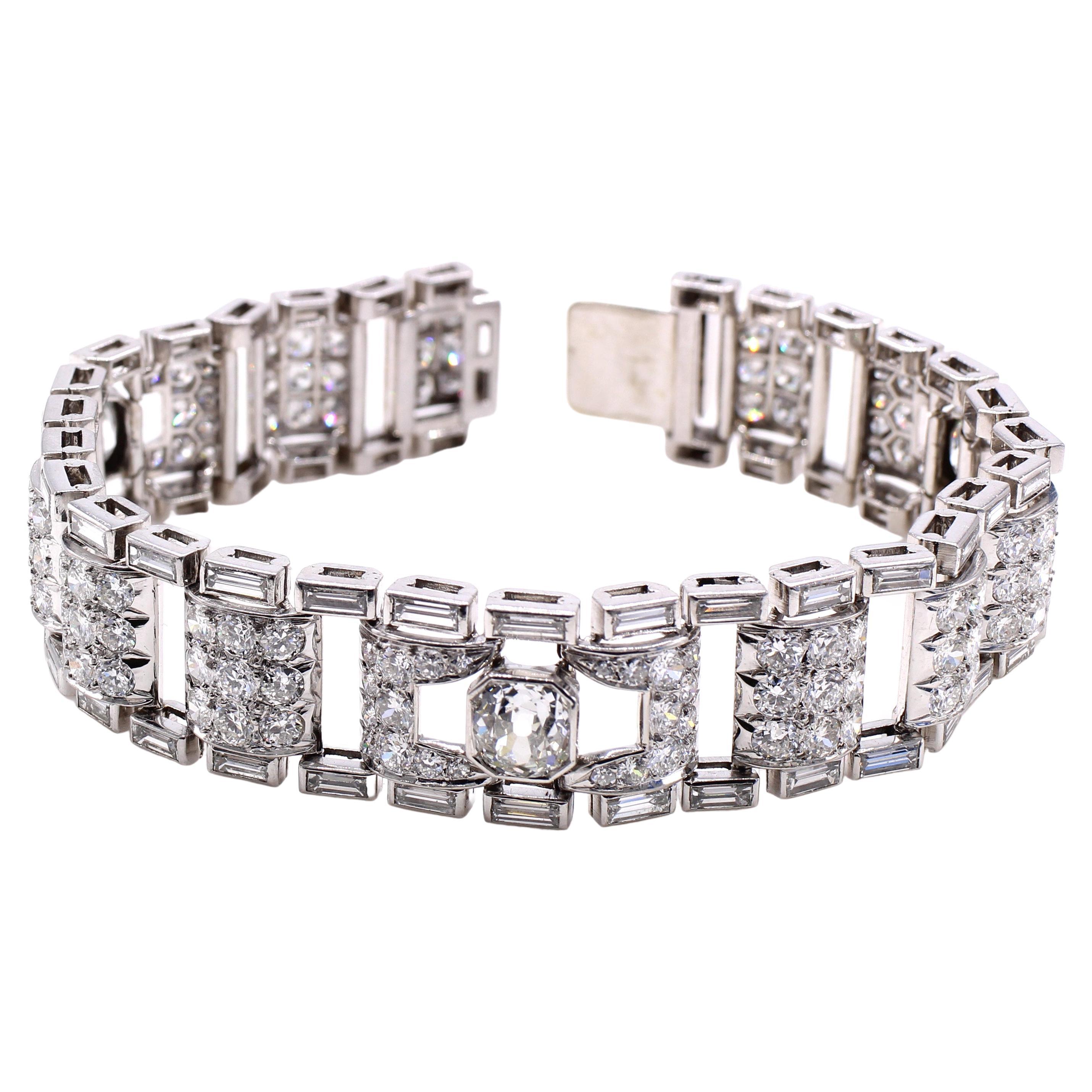Superb Art Deco bracelet made in France ca. 1925. Beautifully designed and masterfully handcrafted in platinum, set with 3 Old European cut diamonds each weighing over 1 carat, in addition to 147 old cut diamonds and 60 baguette cut diamonds. The