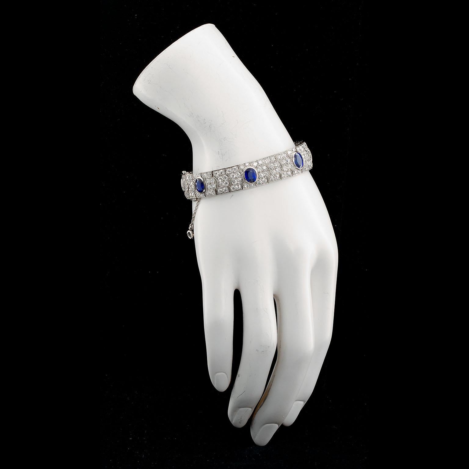 A very fine French diamond and sapphire period platinum bracelet set with approx. ten (10) carats of round diamonds and seven (7) Unheated Burmese oval facet cut Sapphires weighing approx. 15.00 ctw. Made in France with hallmarks.
Measures 7.25