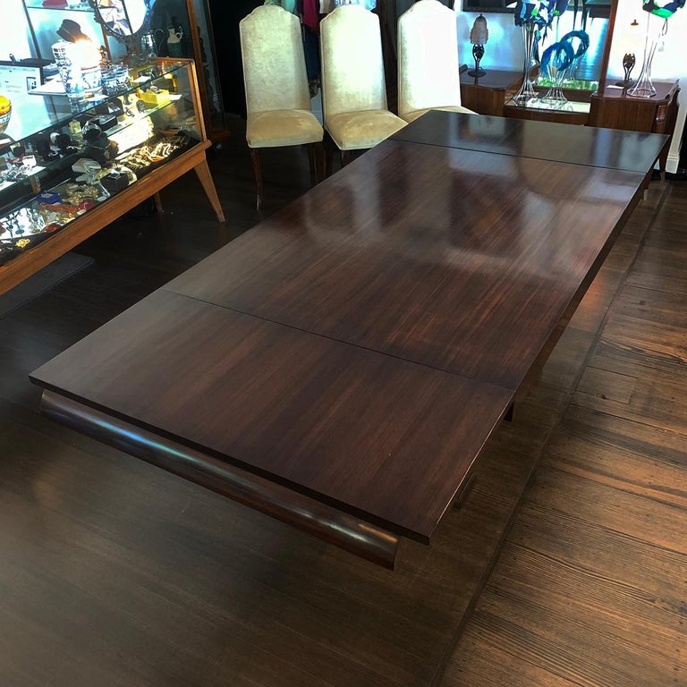 Art Deco French amboyna extension table comfortably seats 6 to 10. Reversed Arch supports and 2 large bronze rails between feet for strength and fantastic visual impact. Each foot also has wide bevels and stepped sides below the lower arch. Internal