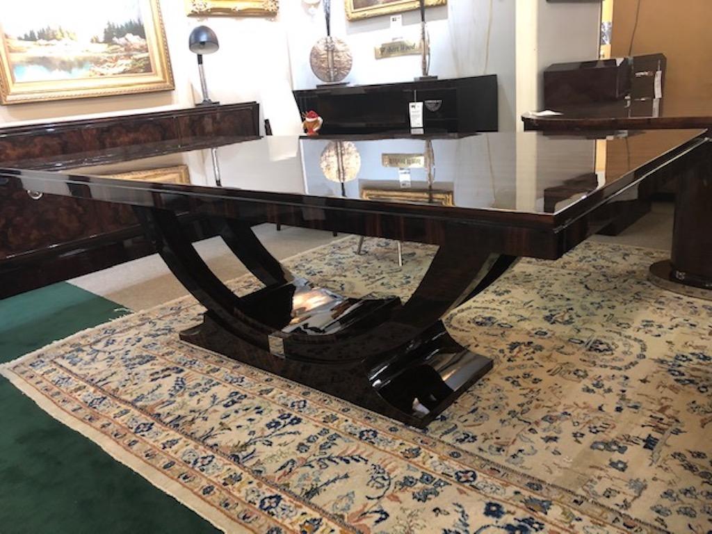 Art Deco French dining table
in Macassar wood

Table is made out of Macassar wood. Tabletop has 2 additional extensions for each side, 20” each. Top is connected to the trapezoid base with 2 semi-circular base. Front of the base and the back has