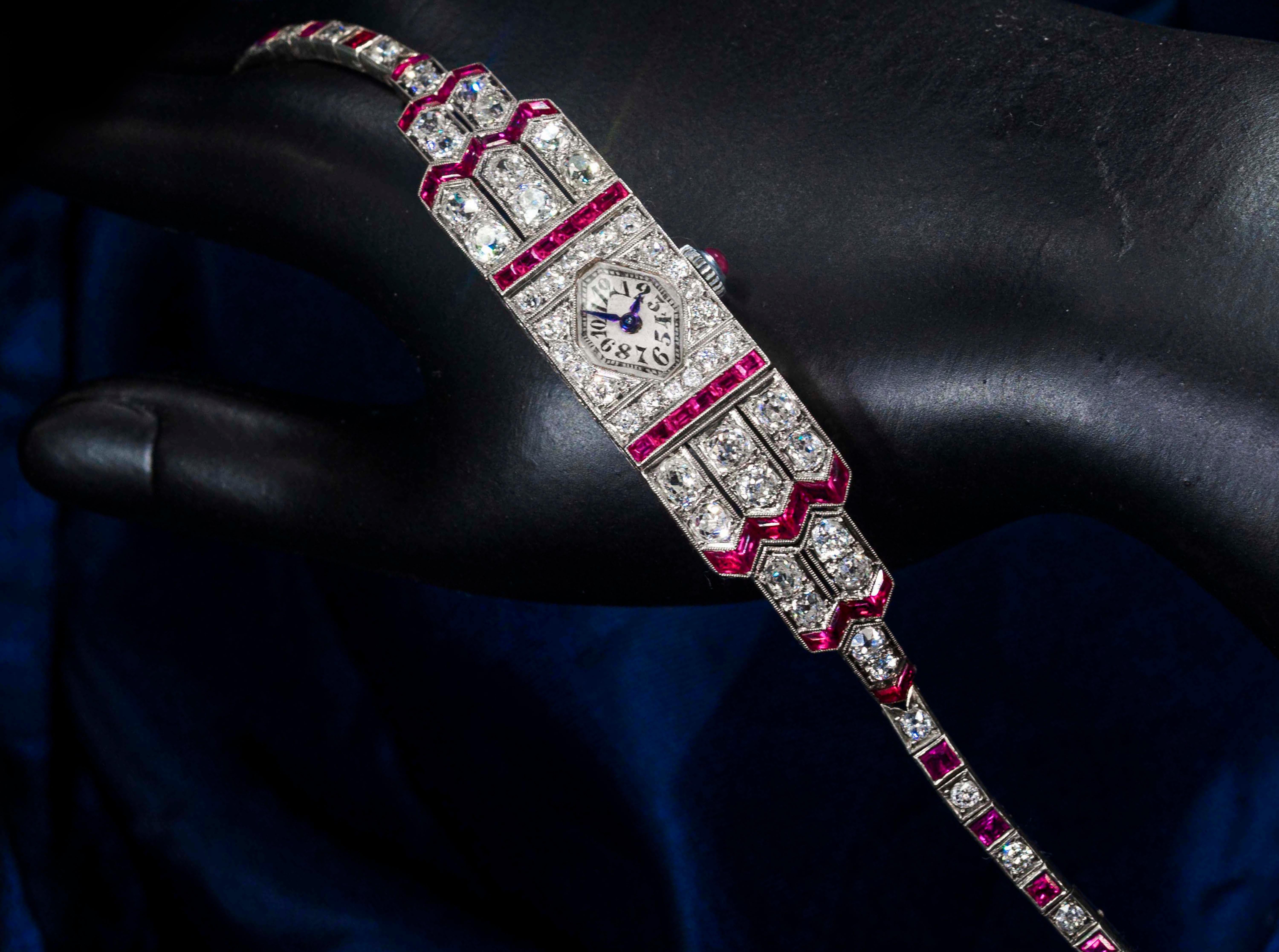 A Rare & Impressive Art Deco 1920s IWC Platinum French Cut Ruby & Old European Diamond Egyptian Revival Motif Bracelet Watch, Approximately 14 Carats      

Basic Specifications & Case Dimensions    
-	14mm wide across x 85mm top to bottom