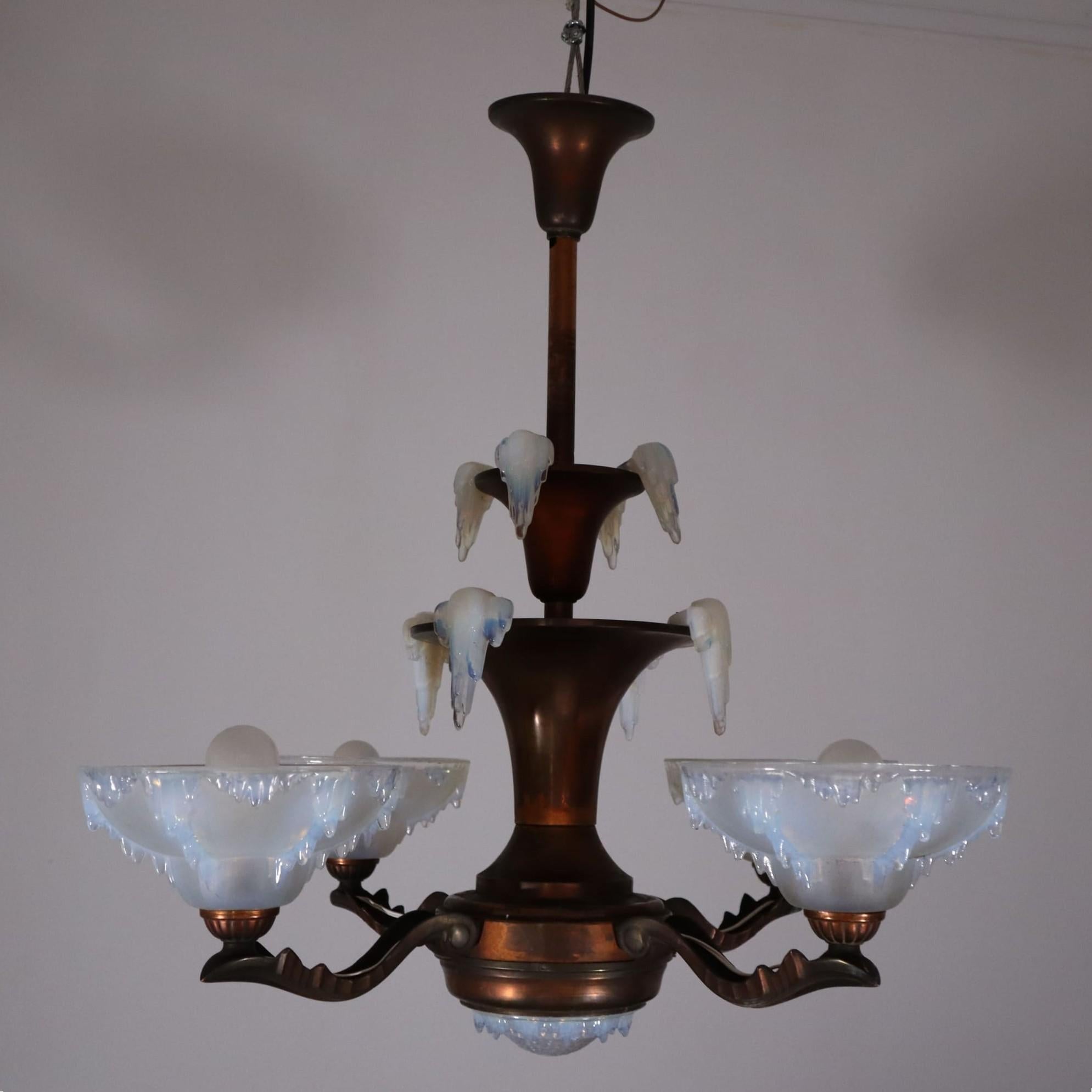Art deco french frosted glass copper chandelier by Ezan, 1930s
1930s French Art Deco Copper Chandelier with Signed Ezan Opalescent Glass Shades

This stunning Art Deco chandelier from the 1930s is a perfect example of French modernist design. It