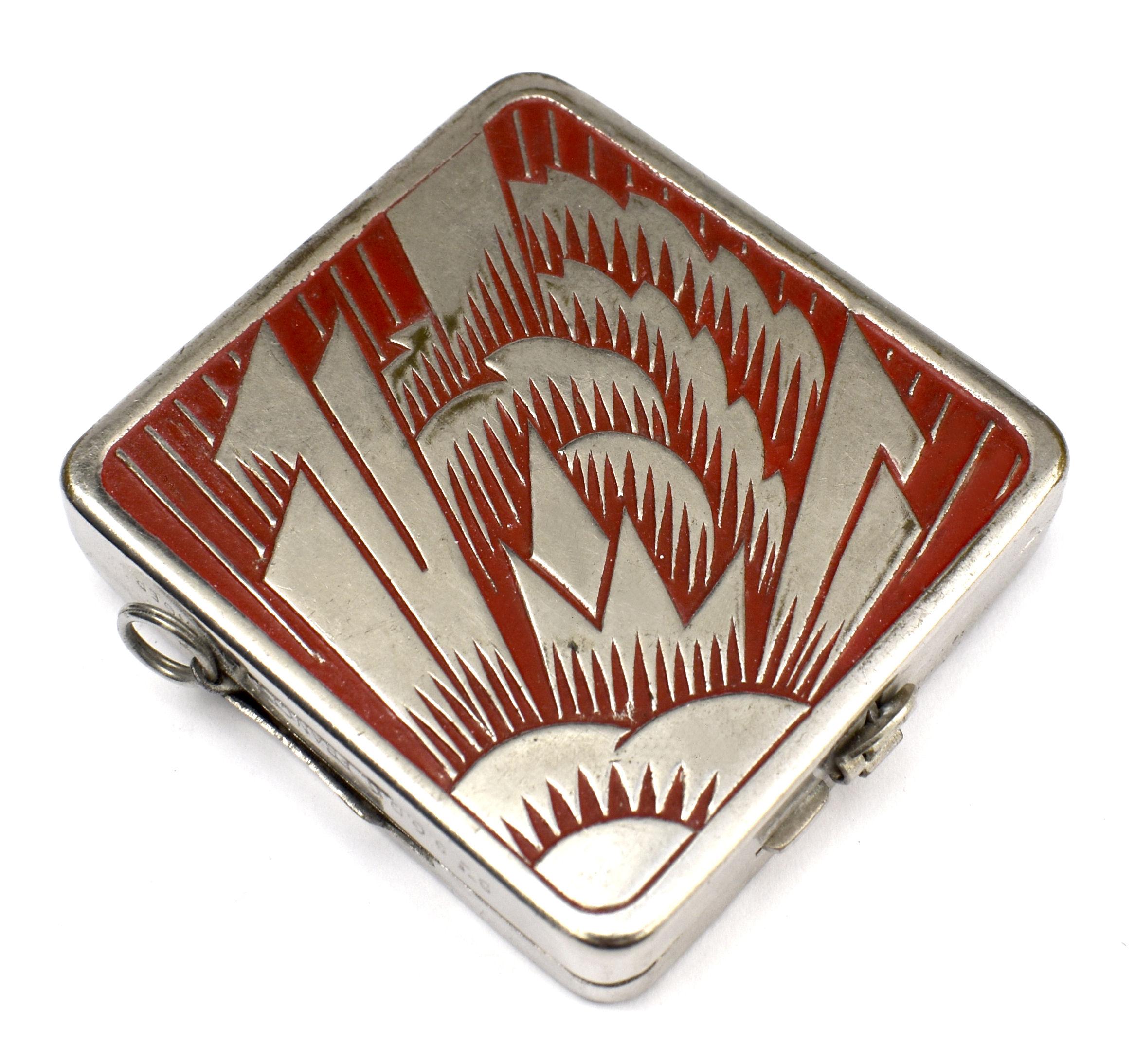 This is a really cute and rare find, a 1930's Art Deco compact with the most delightful enamel decoration, featuring a red geometric design on a chrome casing. The interior is an engineers delight with a sliding latch on the side of the compact to