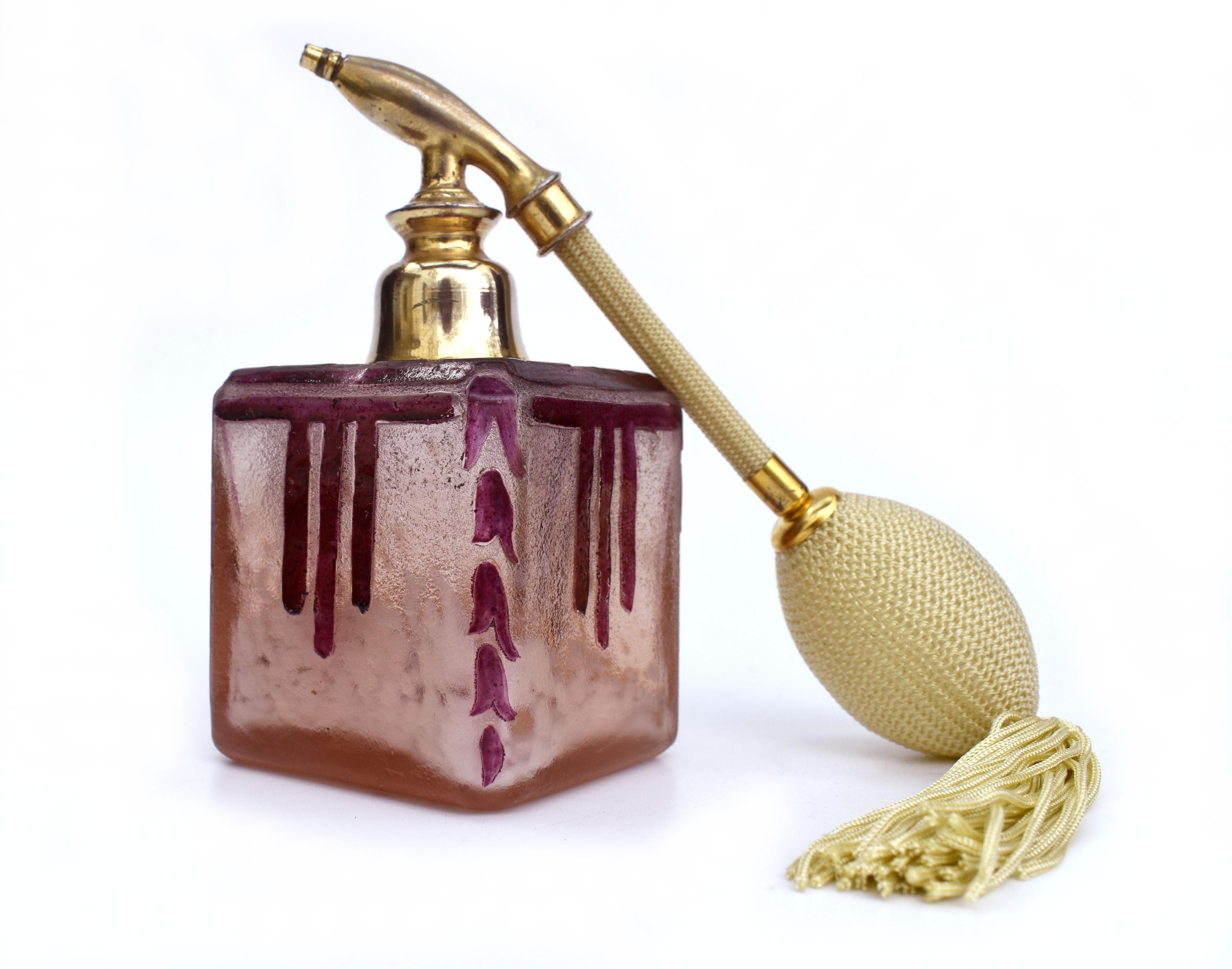 For your consideration is this rather charming and original French ladies perfume atomizer bottle with silk tassel and bulb. Features a square section spray in pale pinky orange colour and cased white mottled glass, the surface is acid-etched with