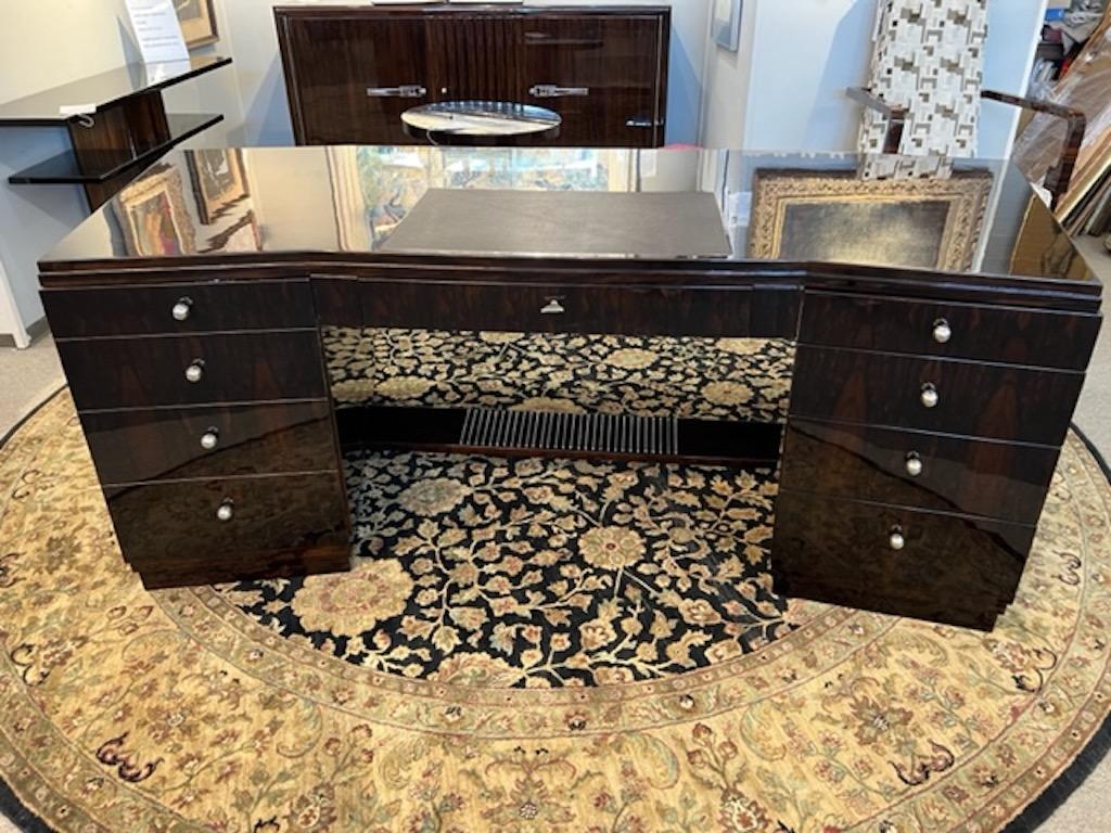 Art Deco table is made out of high quality walnut wood. It composed out of 2 spacious comportments with lots of room/drawers for storage. Both compartments are connected with each other by wooden part, that could serve as a leg support. The table