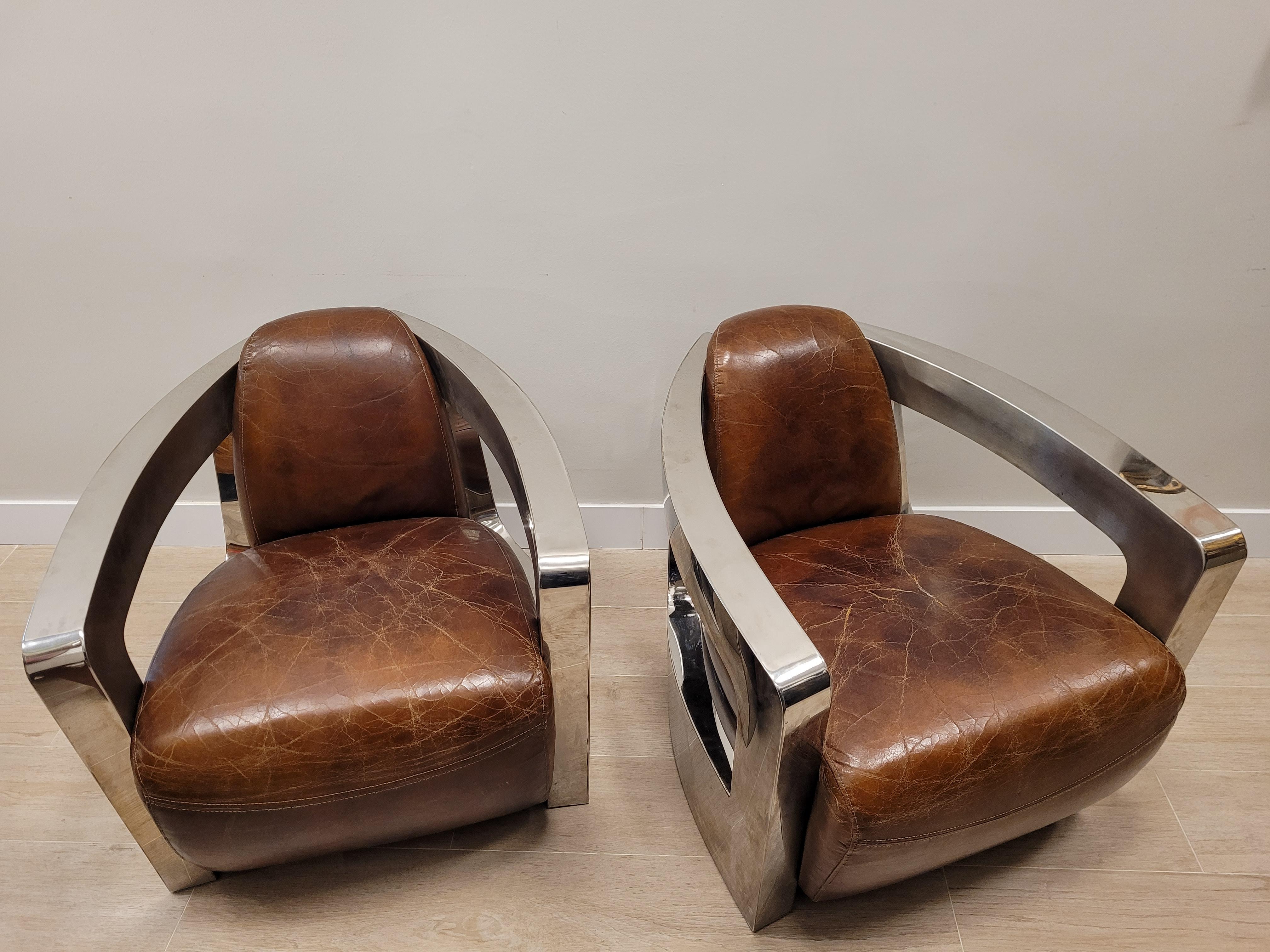 Gorgeous and one of a kind pair of Art Deco style aviator club chair in Classic look with steel and cognac leather. Very comfortable to sit in, very men's club/lounge meets Streamline Modern.
The Aviator Wood and Leather Chair draws its inspiration