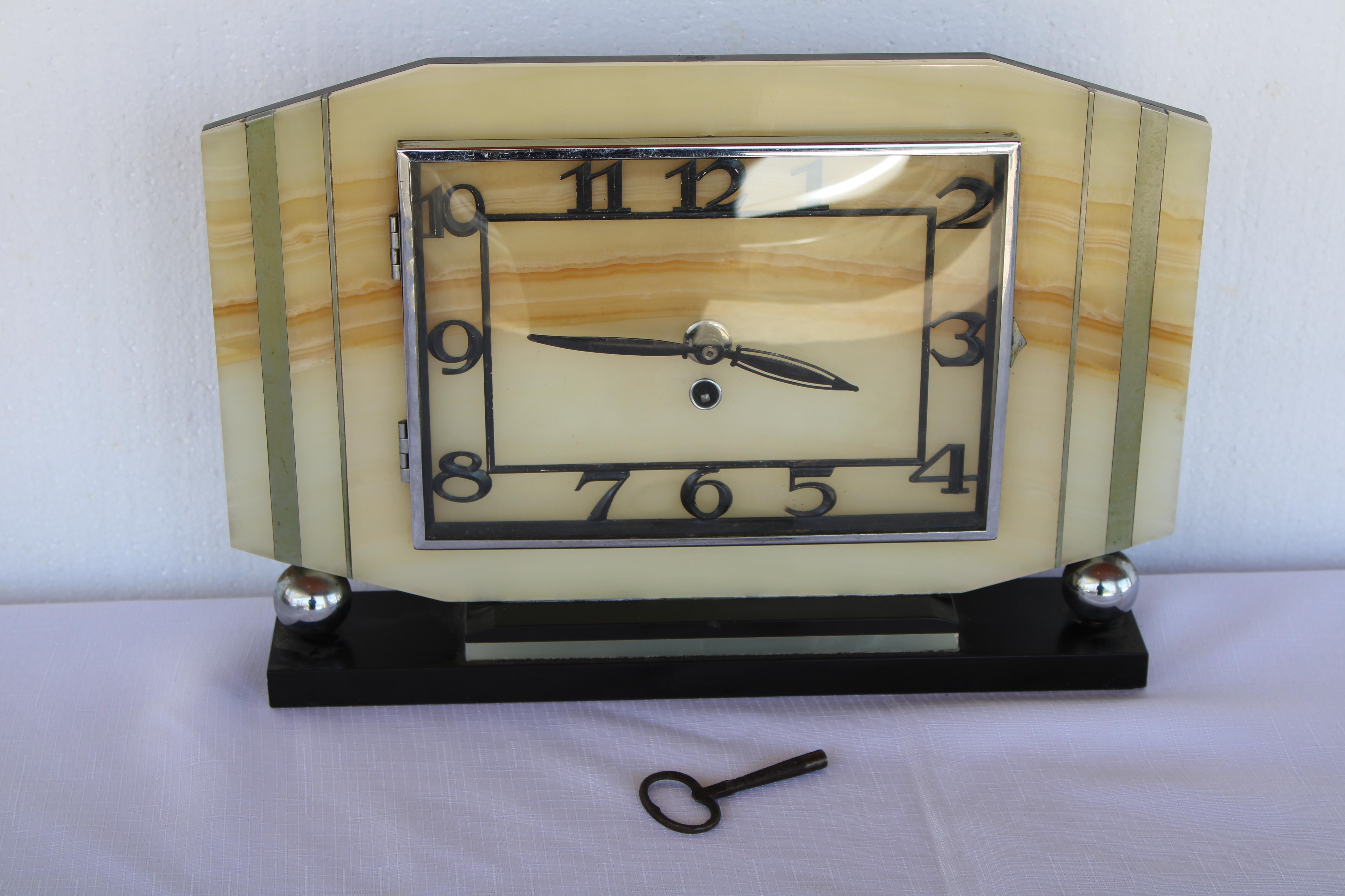 Art Deco French mantle clock consisting of marble and aluminum.  Clock measures 14