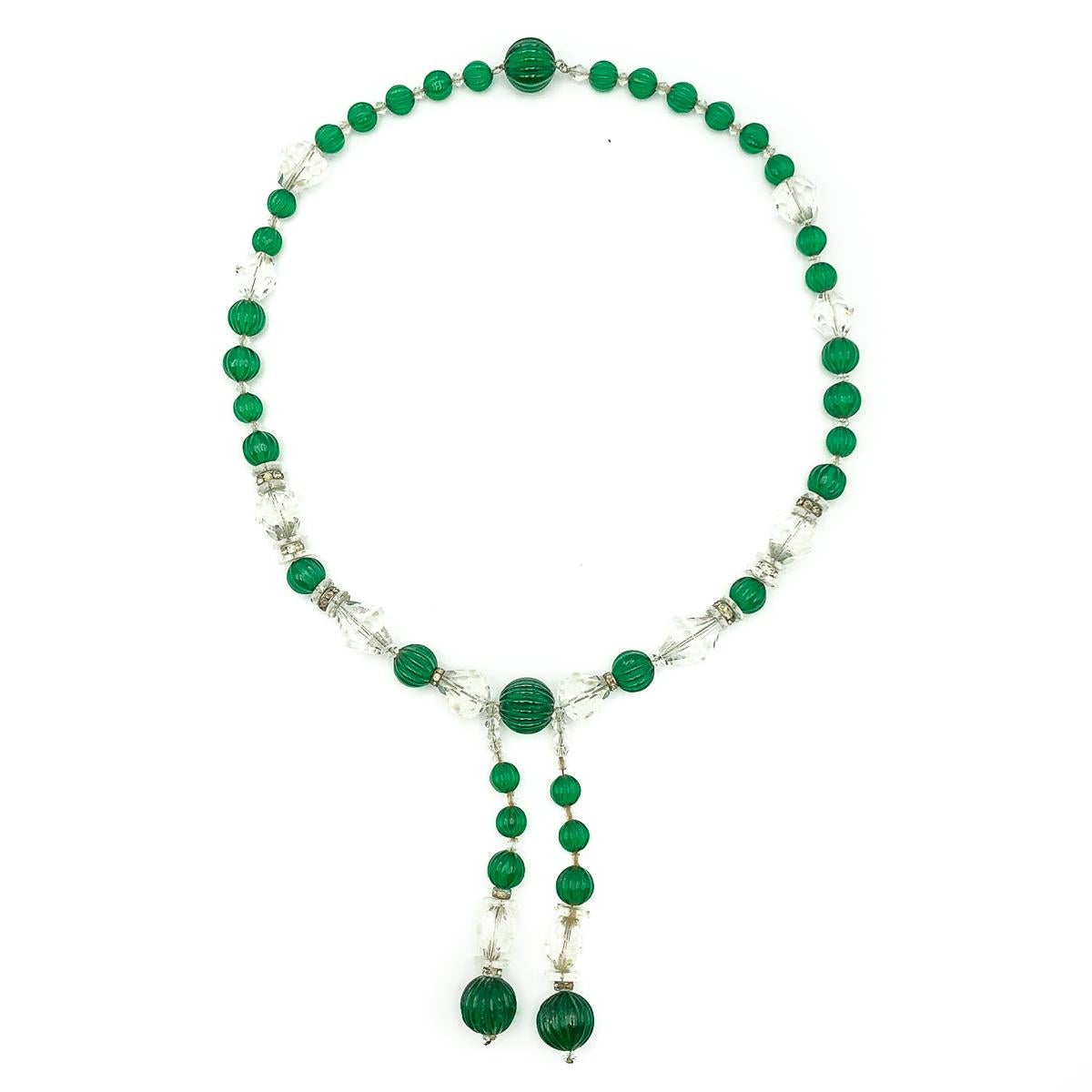 An exquisite and wonderfully rare French, Art Deco green glass sautoir dating to the 1920s. Featuring an impressive thirty six, hand made, emerald glass melon cut beads, in three sizes. Accompanied by delightful clear paste rondelles and a