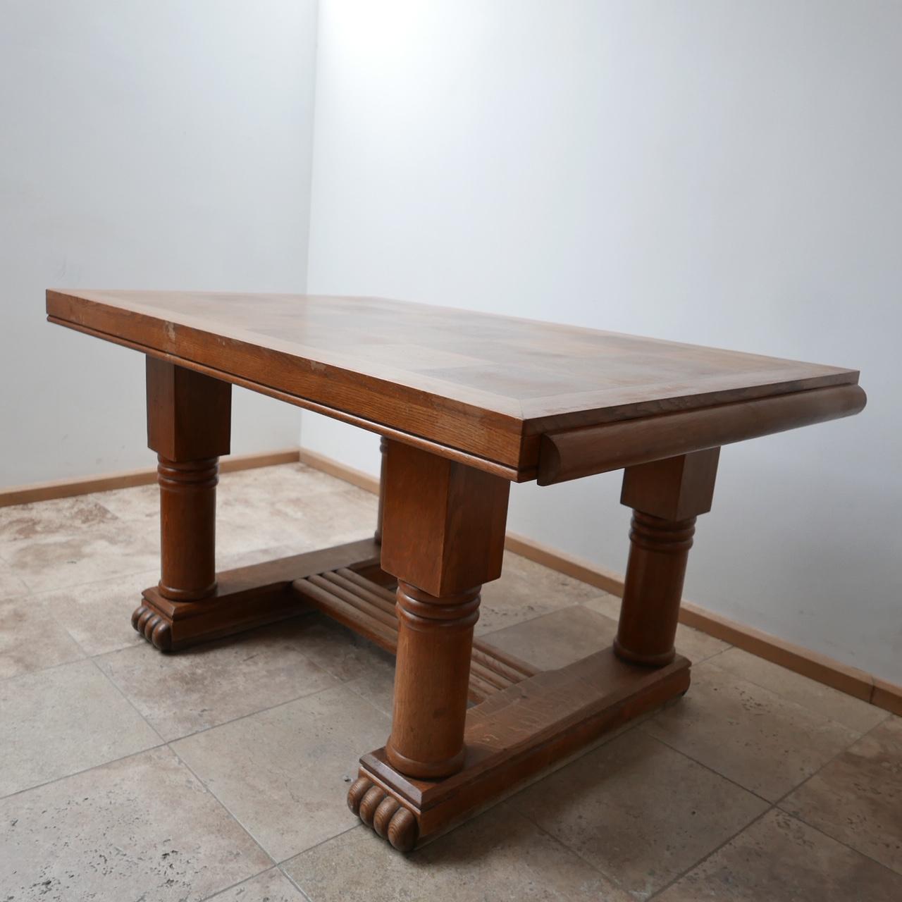 An Art Deco style dining table. 

France, c1940s. 

Oak, the top is formed in a chequer board manner, the base is particularly lovely.

Generally good condition, there is some scuffs and wear commensurate with age. 

There is a simple