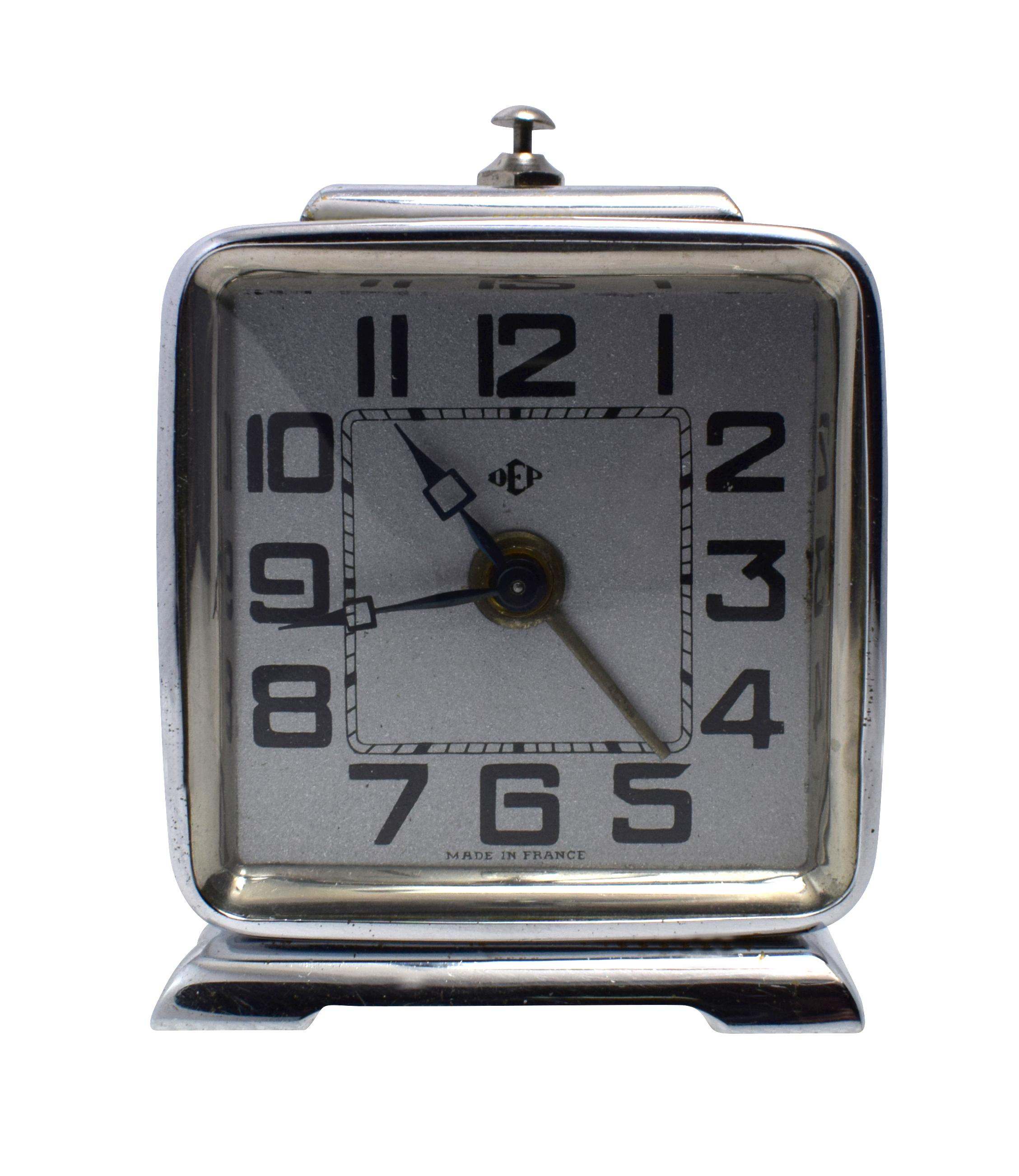 Very stylish 1930s chrome cased alarm clock by the French clock makers Dep. This charming little clock has a silvered dial face with bold black numerals making an attractive contrast and appealing look. Slender shaped and free standing with good