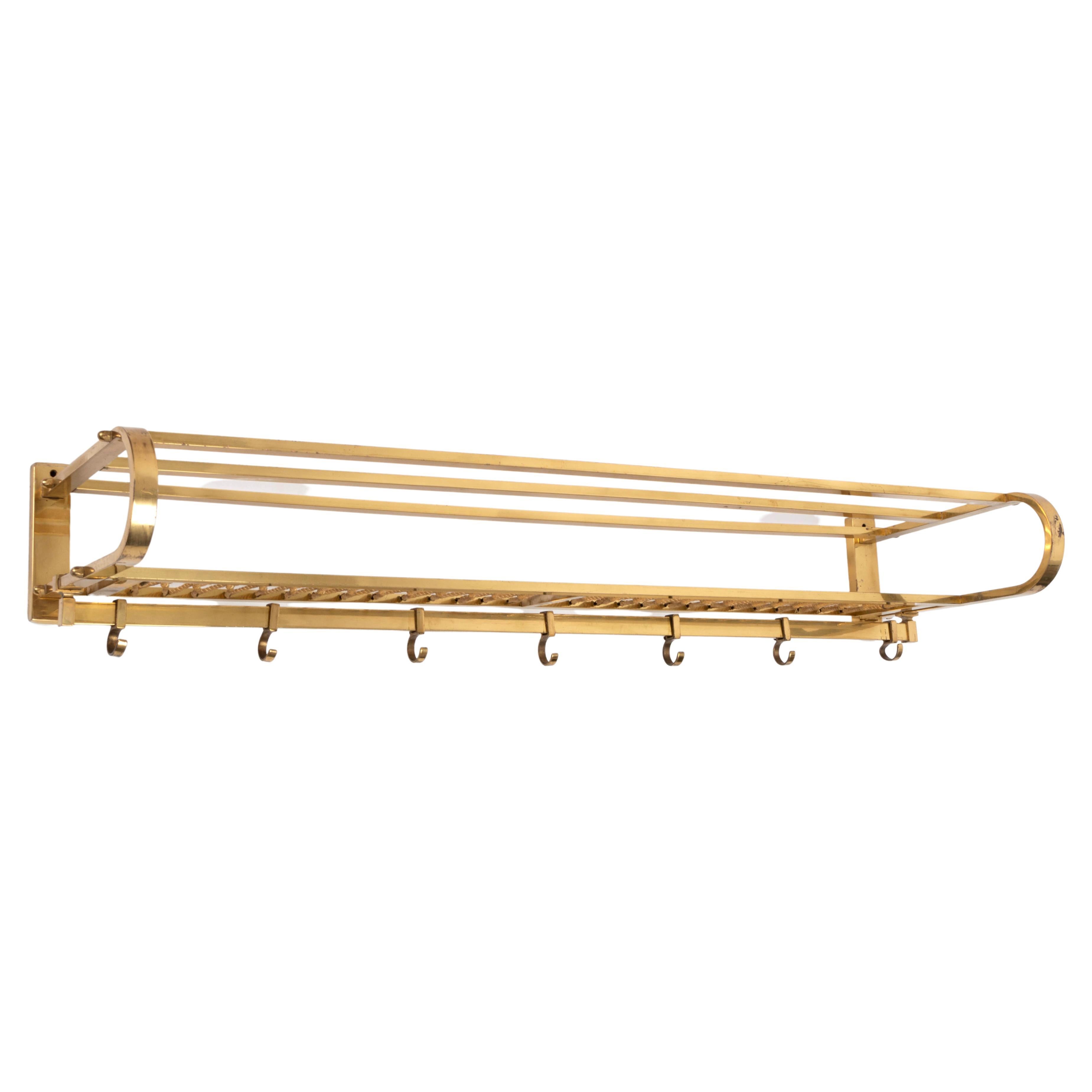 Art Deco French Modernist Brass Coat Rack & Rail 
La Maison Desny C.1920

A large French brass coat rack, fitted with a hanging rail and seven adjustable hooks. Excellent condition commensurate with age.

Measures: 99cm wide 15cm deep 32cm high.