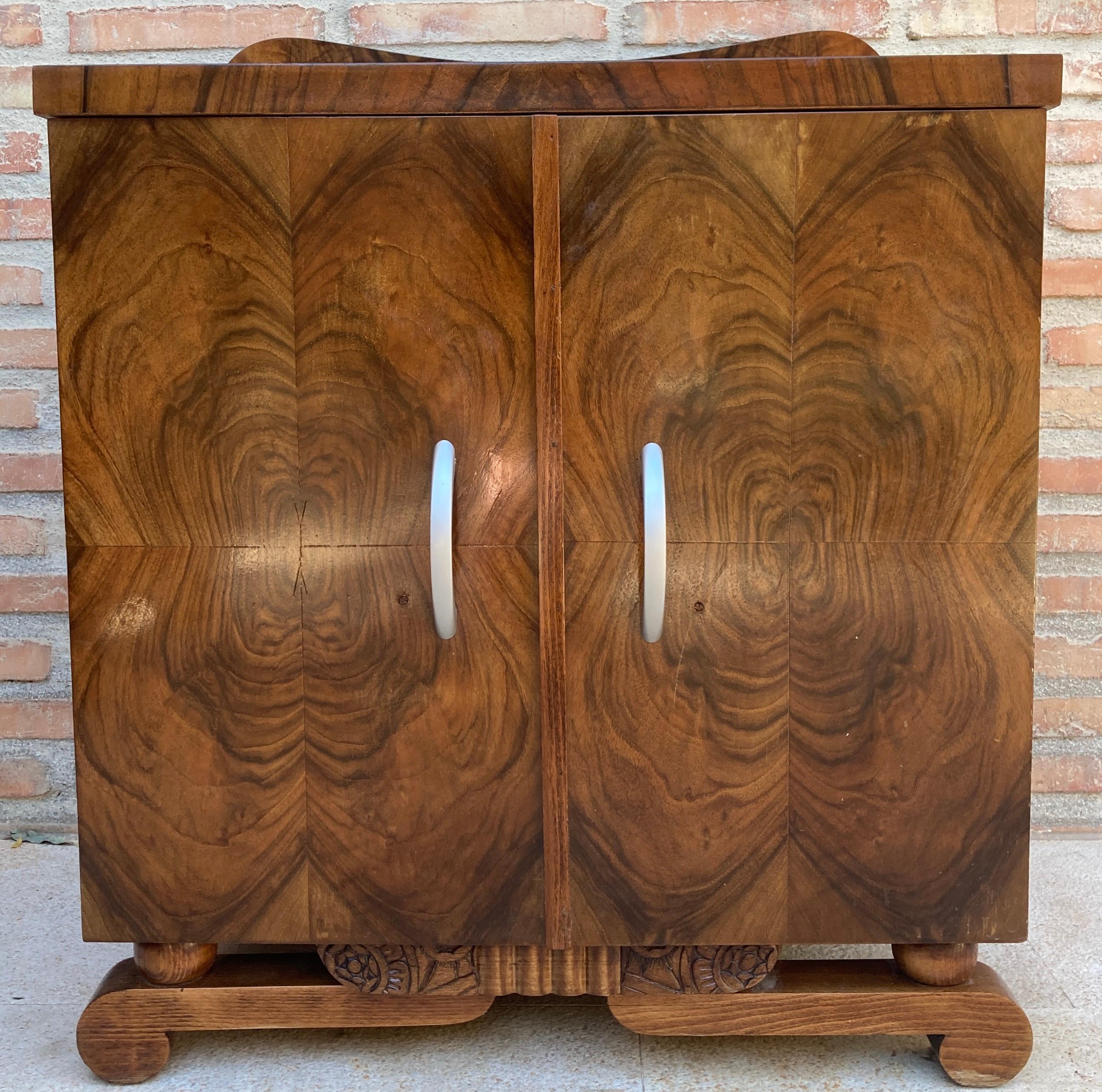 This pair of French Art Deco side cabinets from the circa 1930s could be used to flank a sofa or as nightstands. Each has a storage compartment with a hinged door. Opening the door we find a drawer and open top shelf and 2 narrower open square