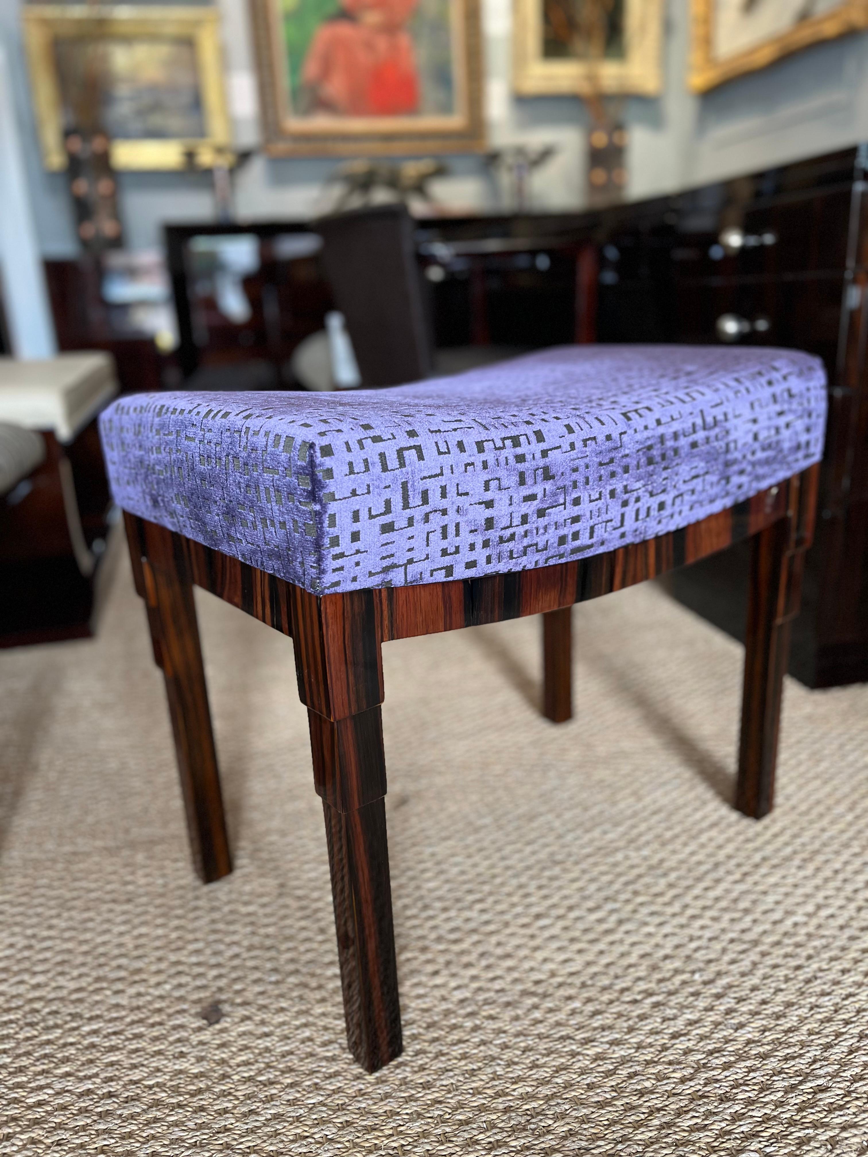 Art Deco Period French Ottoman is made out of Macassar night. Newly re-upholstered in velvety purple  fabric. Semi-curved seat is resting on 4 rectangular legs. 

France. c. 1930
Condition is perfect. Restored.
23.5