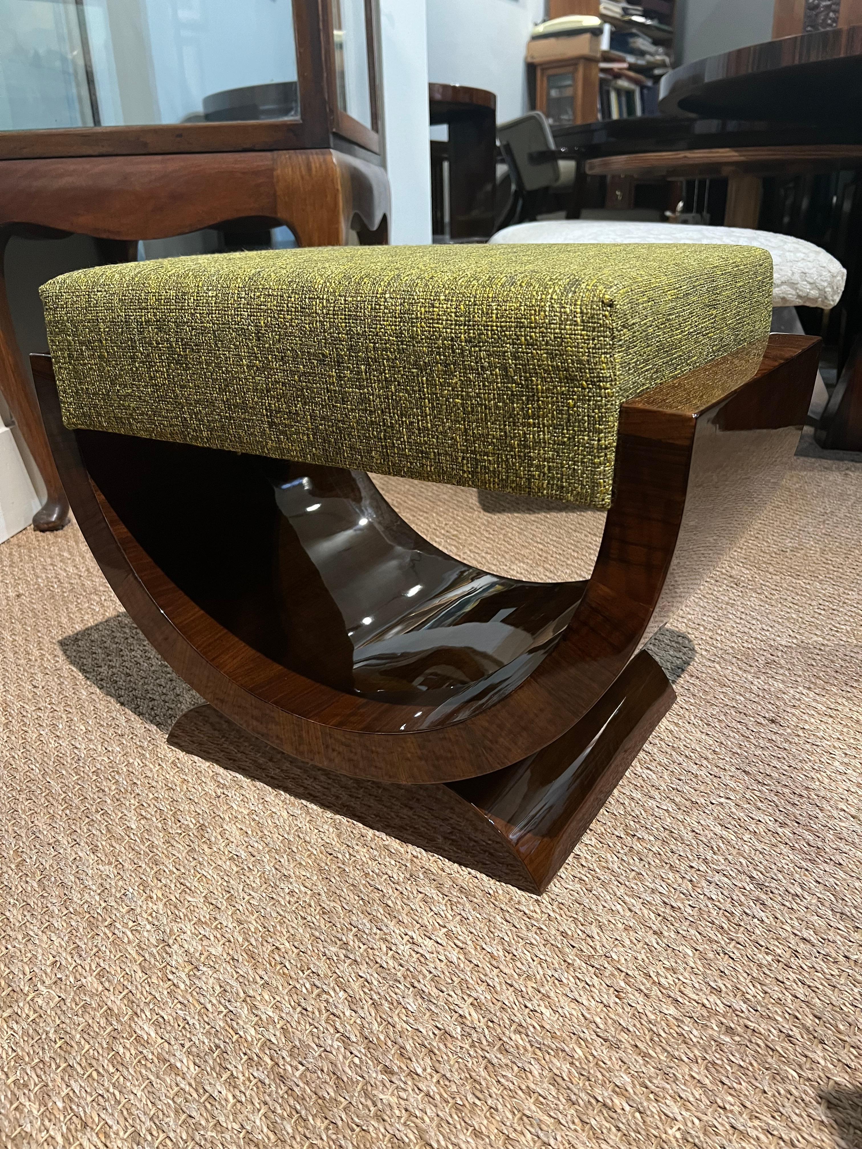 Beautiful Art Deco ottoman from France made out of high quality walnut wood. Comfortable sit is supported by the semi-circular leg that is attached to the trapezoid stable base. Ottoman is newly re-upholstered  with light green fabric and