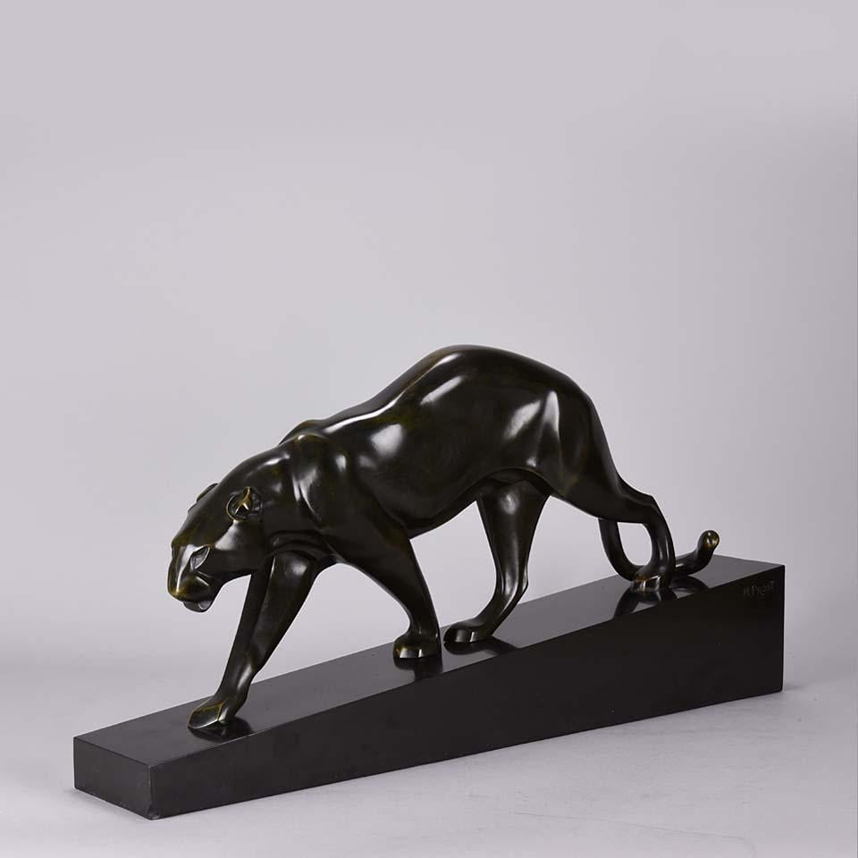 A striking iconic early 20th century Art Deco bronze study of a prowling panther with rich black patination lightly rubbed to a golden hue on the raised areas, which captures the eye and heightens areas of definition on the surface. Raised on a