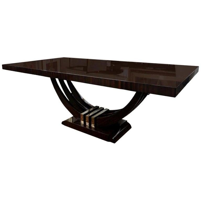 Art Deco French dining table
in Macassar
Table is made out of Macassar wood and the beautiful wood grain is clearly shown on the tabletop. 3 semi-circular legs are connected with each other in the middle by 3 chrome brackets. Trapezoid shape base