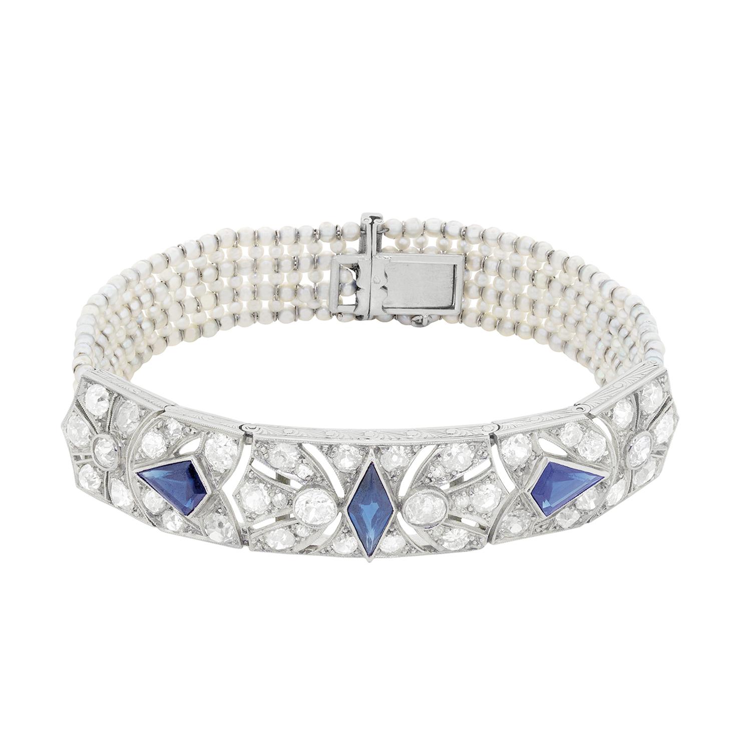 This beautiful and elegant bracelet dates back to the 1920s and is French in origin. The main attraction is the three rub over set diamonds in the centre of the piece. They have a combined weight of 3.00 carat and are a luscious deep blue. The rub