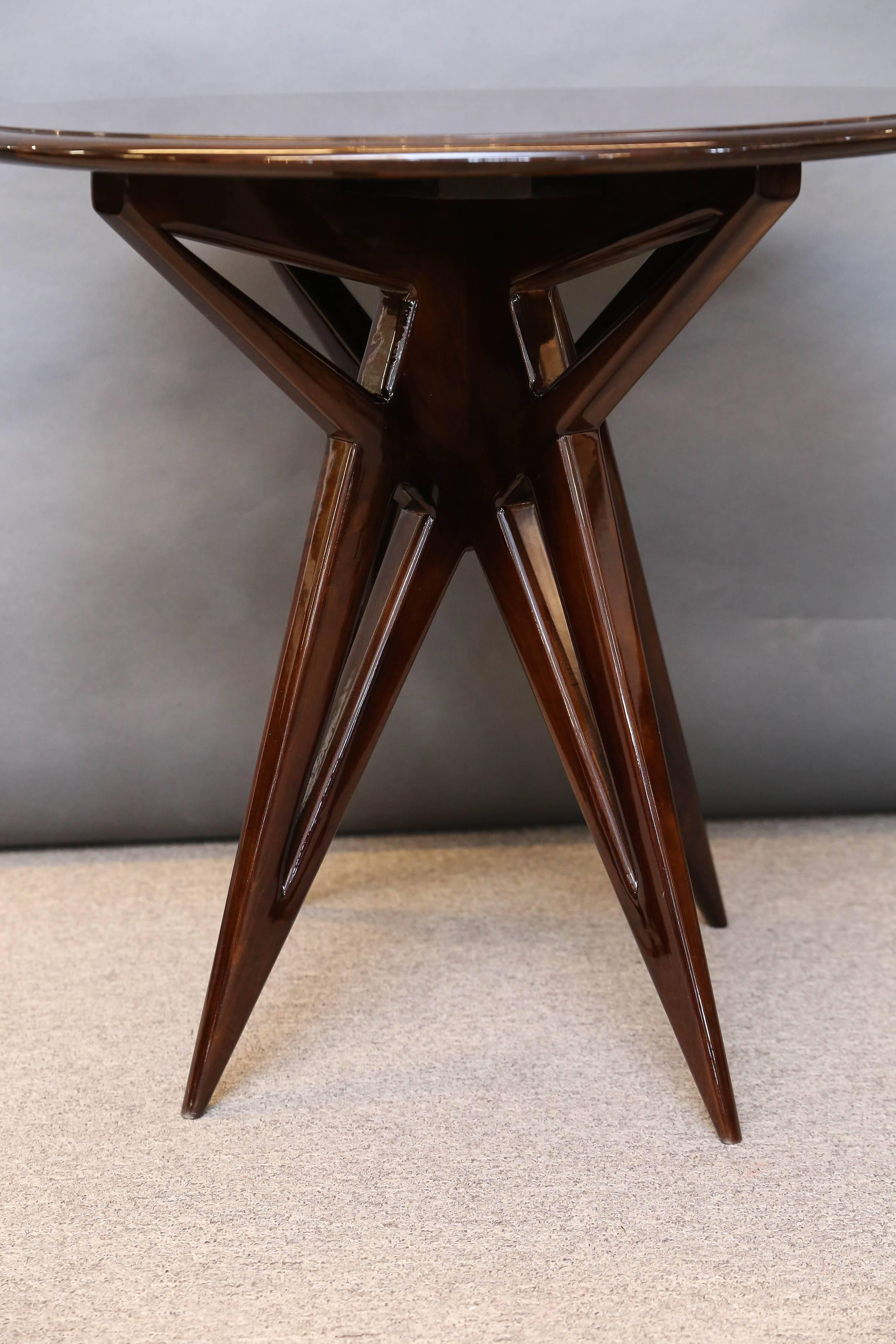 Table top has round highly polished form that presents high quality walnut wood grain. Each table is elevated by three pointy legs that have decorative opening in the middle. 

 Condition is perfect. Restored. 

 France, circa 1940s.

 Measures: