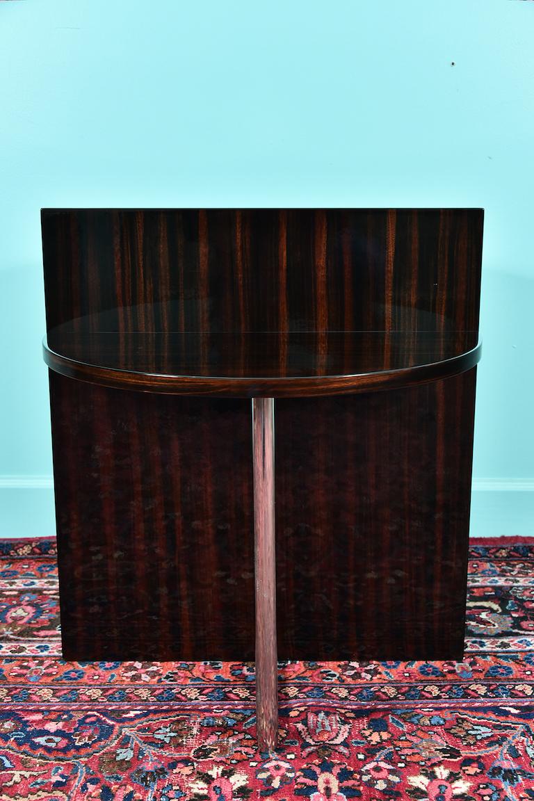Art Deco French side tables in walnut and chrome

A very unique pair of side tables are composed out of walnut board with double semi-circular table tops, which are connected on the bottom by the chrome tube. 
Condition is very good. 

French, circa