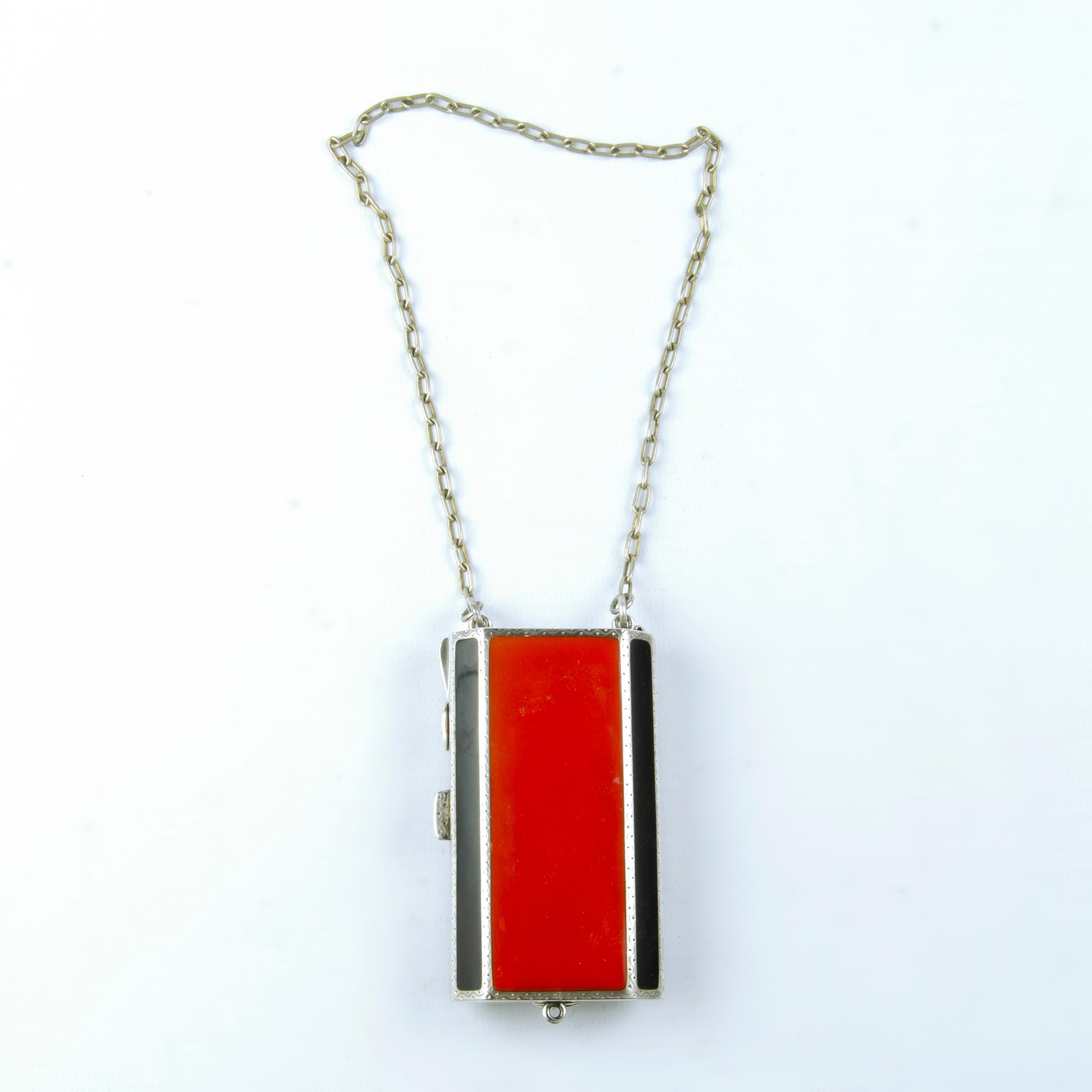 Art Déco French silver and enamel vanity compact necklace/pendant with mirror, 1940s

By: unknown
Material: silver, metal, enamel, mirror
Technique: silvered, polished, metalwork, cast, molded, enameled
Dimensions: 1 in x 2 in x 4 in
Date: Early