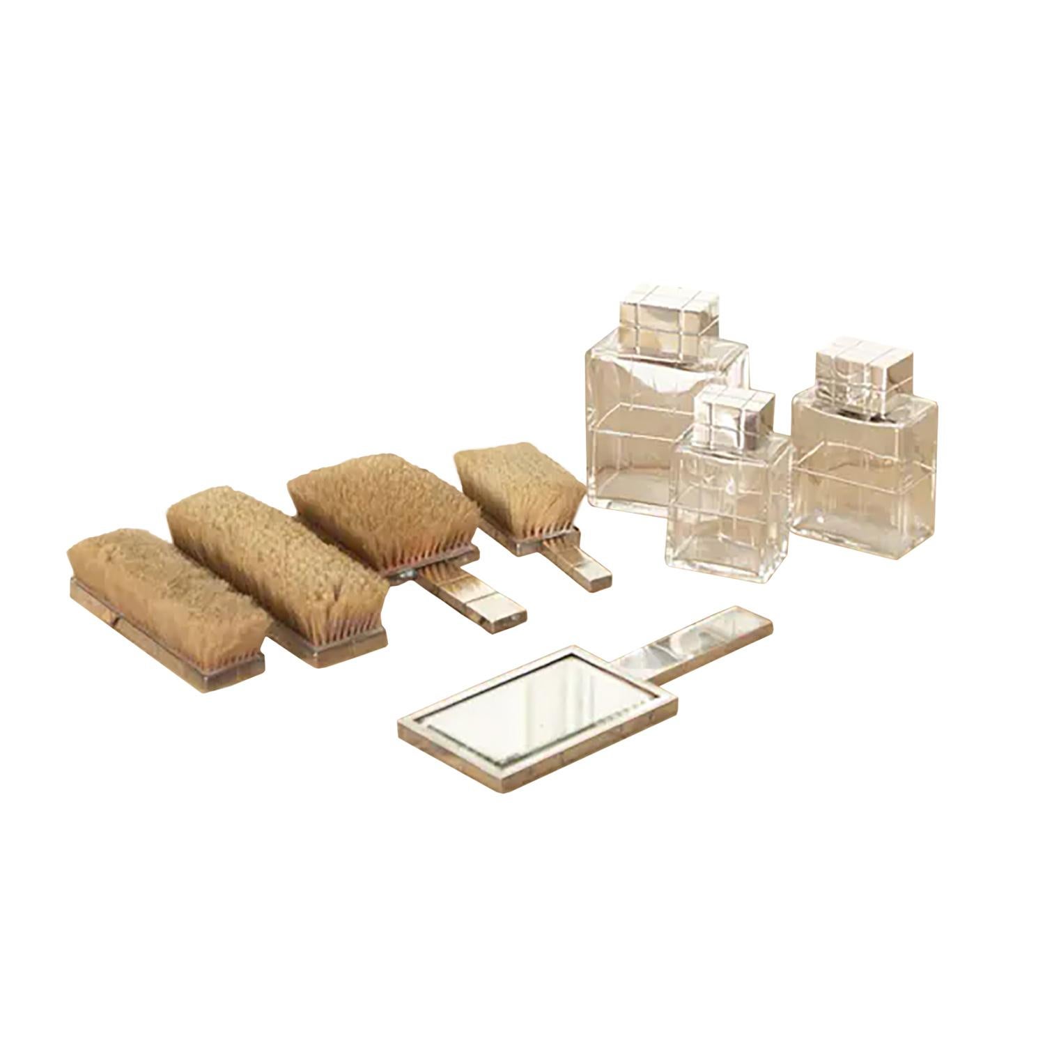 A superb quality French Art Deco dressing table set consisting of three graduated cut glass bottles, three bristle brushes and one bevelled edge hand mirror French hallmark.
  