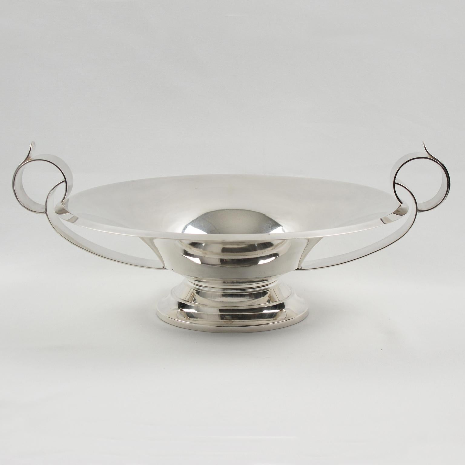 French Art Deco polished silver plate pedestal bowl, great centerpiece, or serving bowl. Modernist design with a round stepped bottom, a funnel-shaped dish with a flat bottom compliment with large loop handles. Signed on edge with legal silversmith