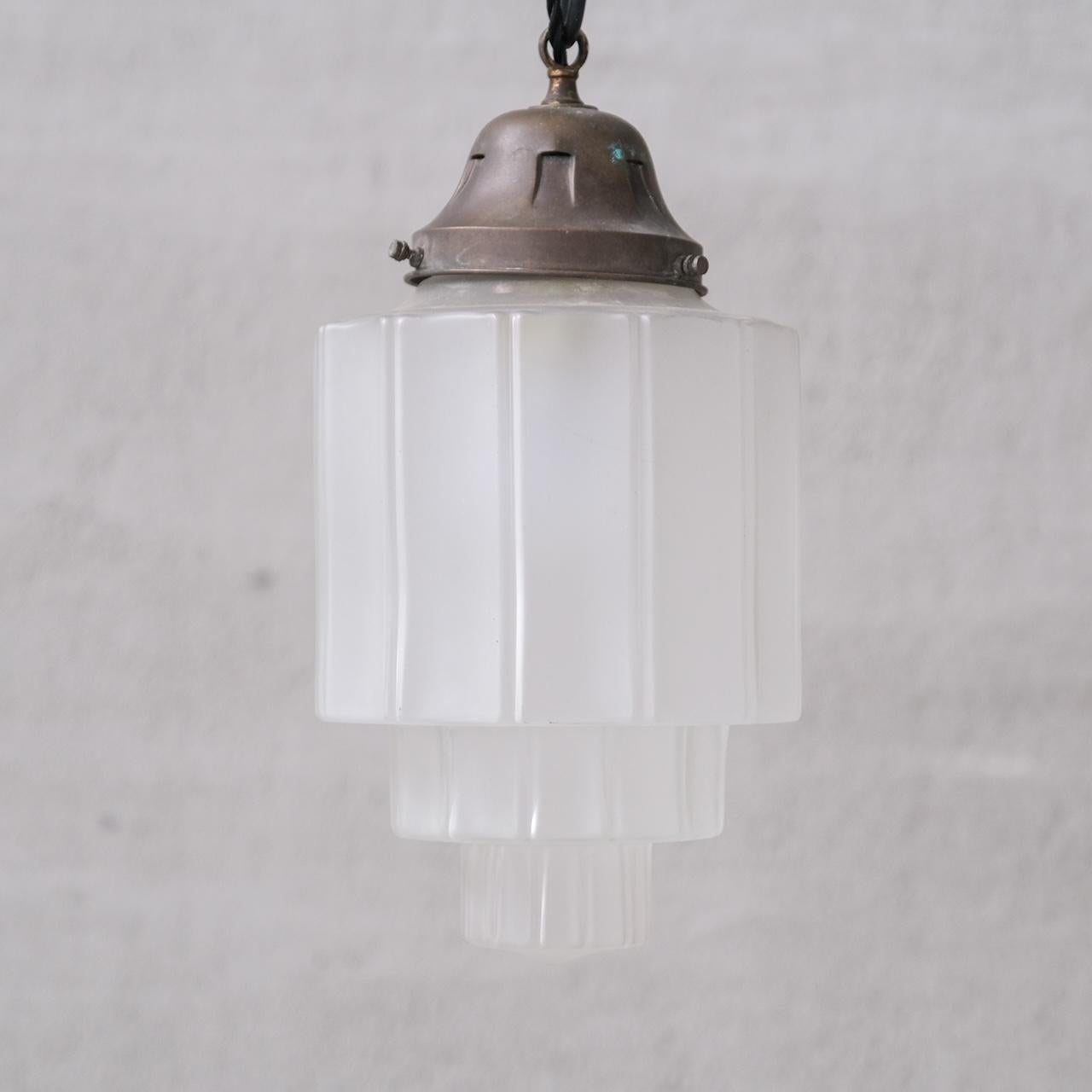An opaque glass pendant light, often labelled as 'sky scraper' pendants.

France, c1920s.

Stepped design.

No chain or rose was retained, however they are easy to source online.

Good vintage condtion, re-wired and PAT tested.

Location: Belgium