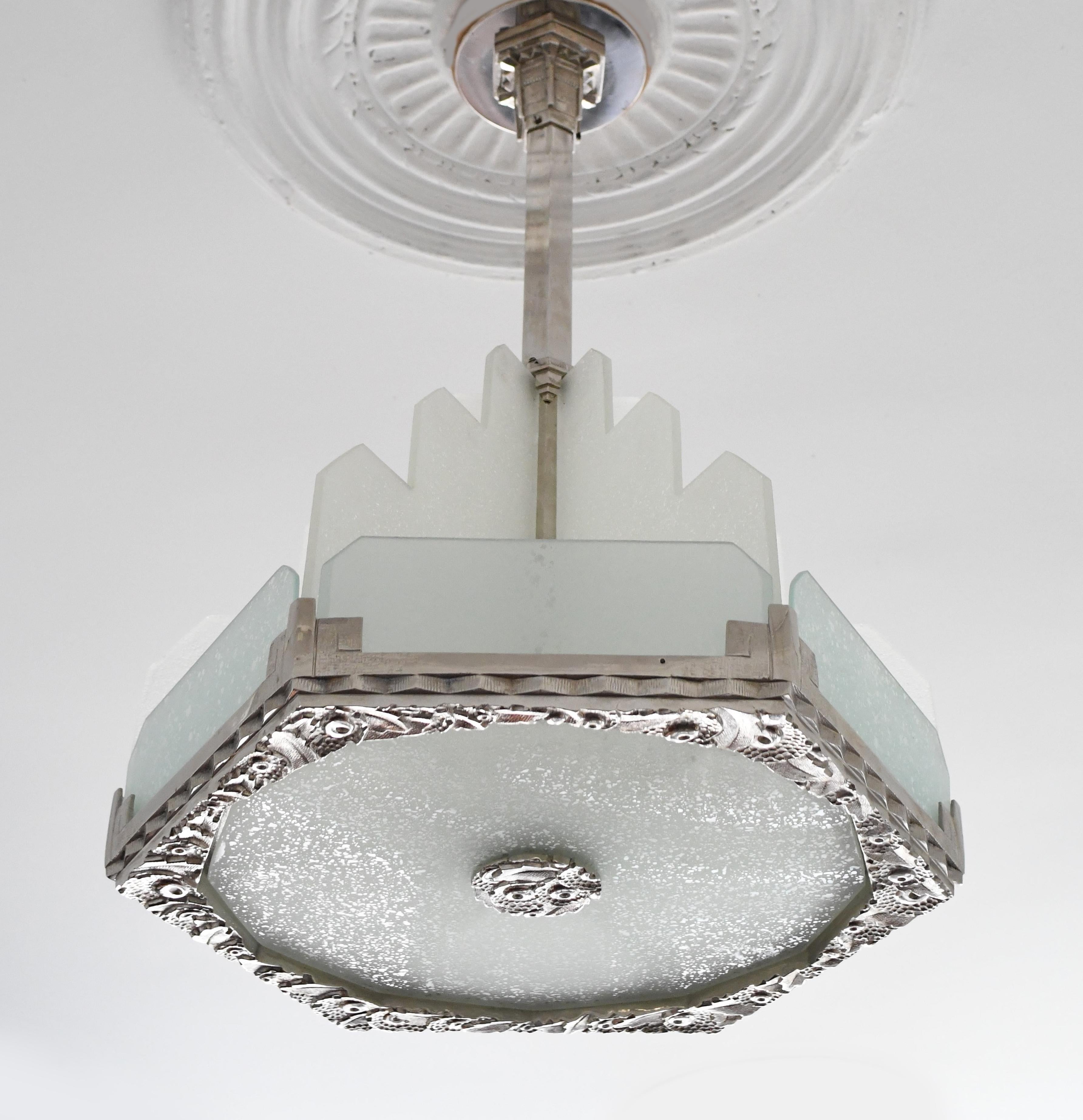 Stunning Art Deco chandelier from France, 1930s. Quality made with thick frosted glass in stepped skyscraper design and highly detailed chrome throughout. Chandelier has been rewired and is ready to hang. There are six candelabra based bulbs