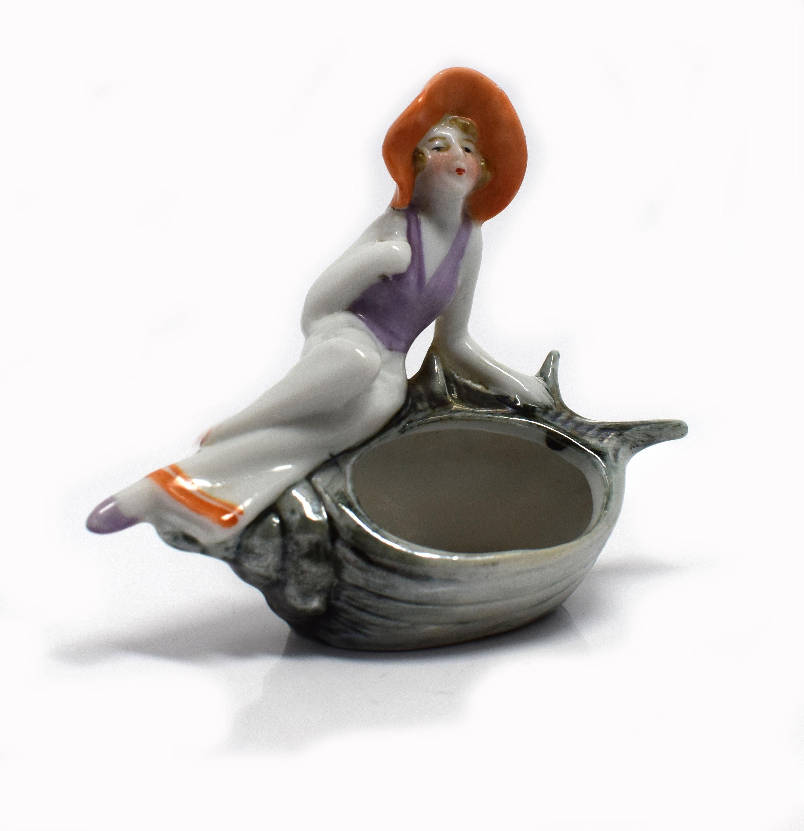 For your consideration is this delightful early 1930s Art Deco porcelain souvenir tray. Depicting a young girl dressed in a sailors outfit with a large floppy hat on a conch shell and originating from France. Beautifully hand painted with lovely