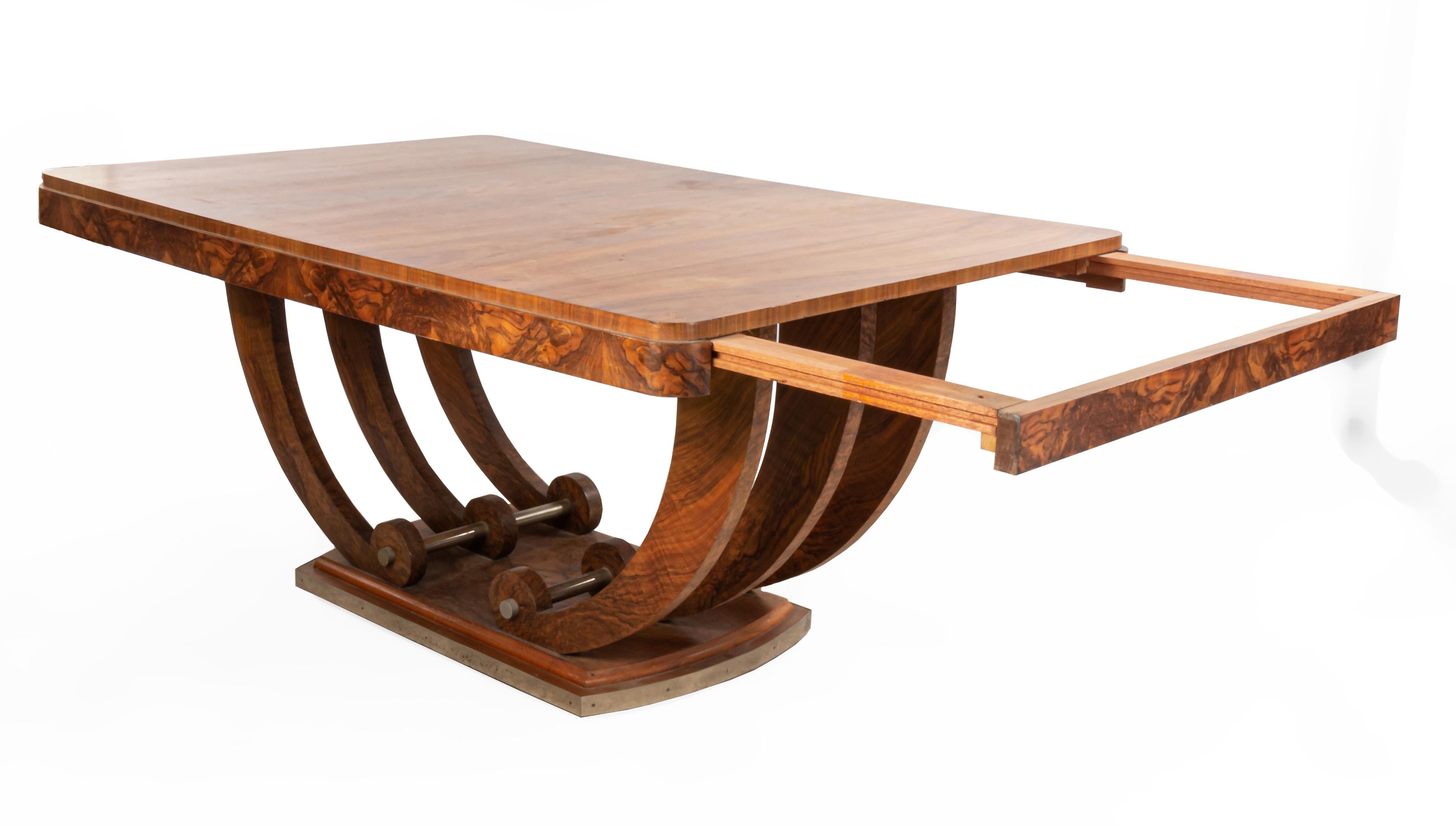 French Art Deco burl walnut rectangular table with curved edges supported on a treble stretcher U-base with metal accents.