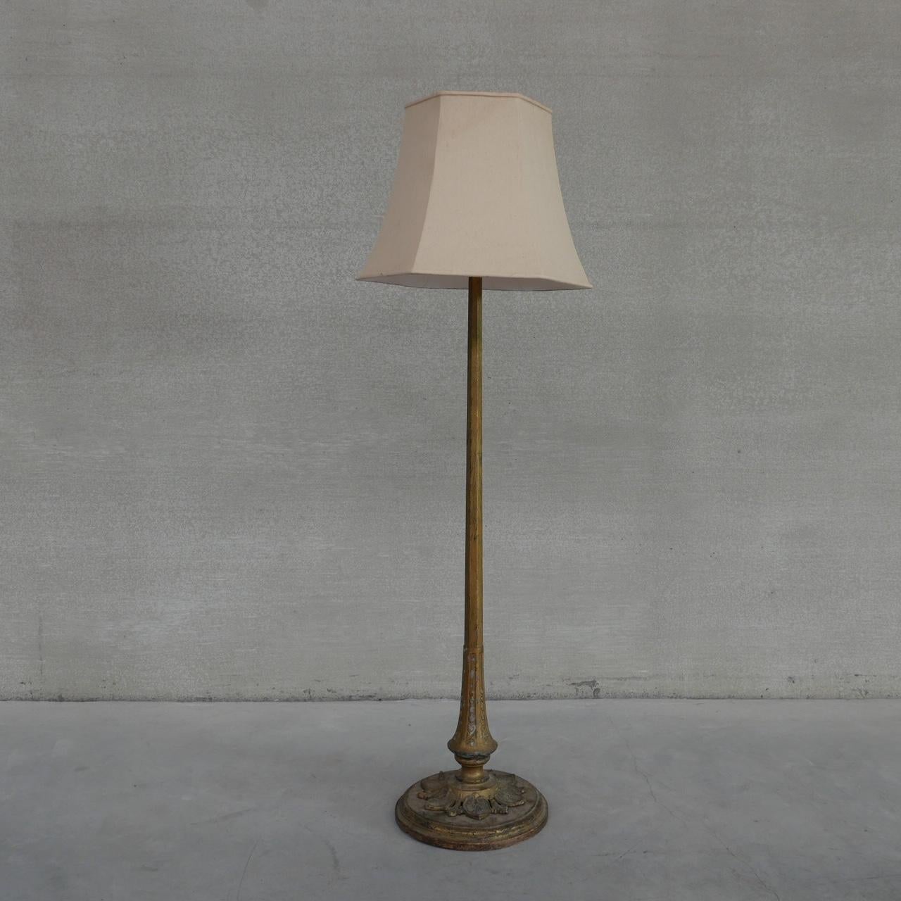 A metal and wooden floor lamp. 

France, c1930s. 

Lovely decorated base slopes up to an elegant stem. 

Great patina, some wear to the paint or gilt but it looks amazing. 

The original shade is damaged so is shown as demonstrative purposes