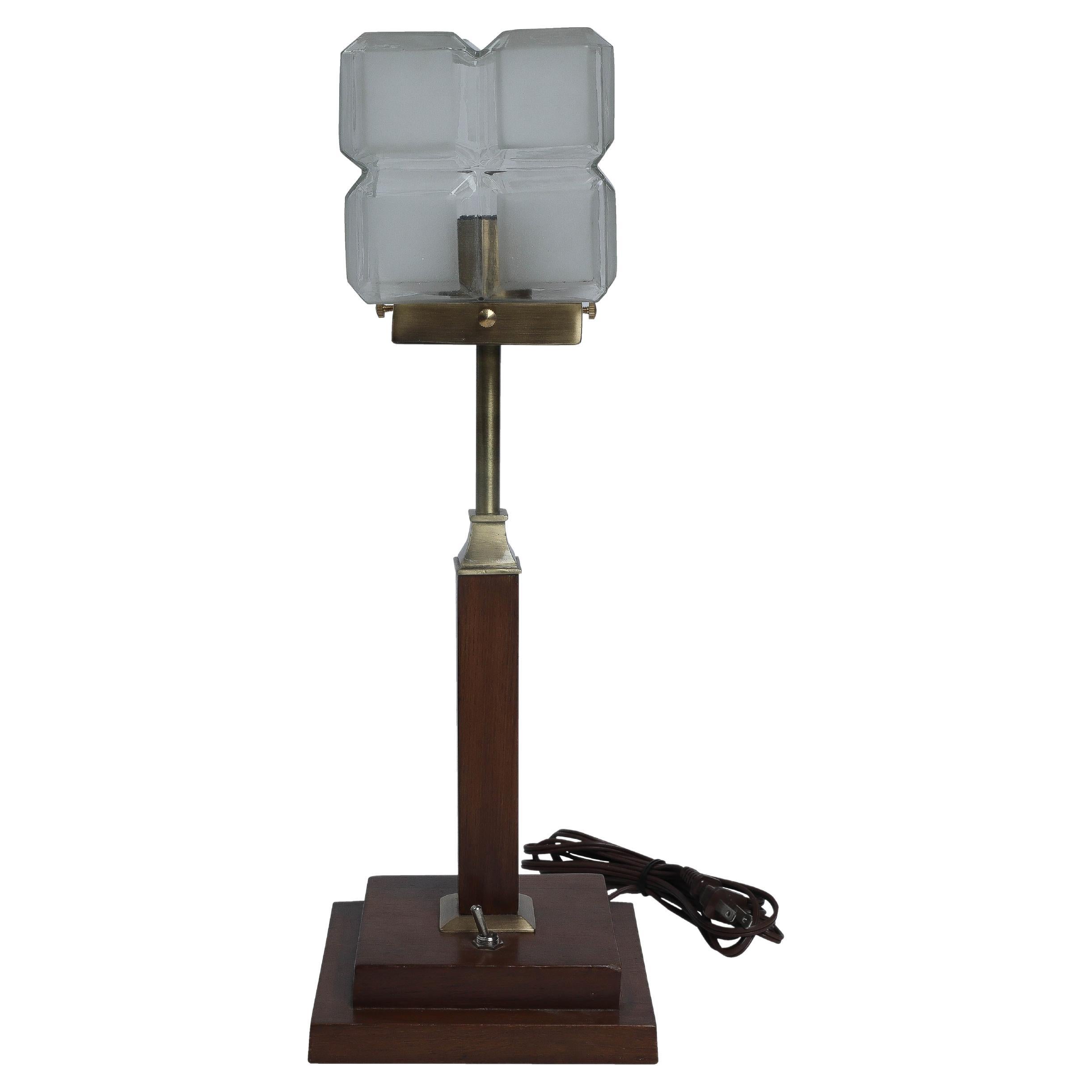 A frosted European art glass shade mounted on a teak and brass table lamp. The shade is from the Art Deco period with clear glass between the squares on all four sides, and the base is more recent. The shade itself is a 5
