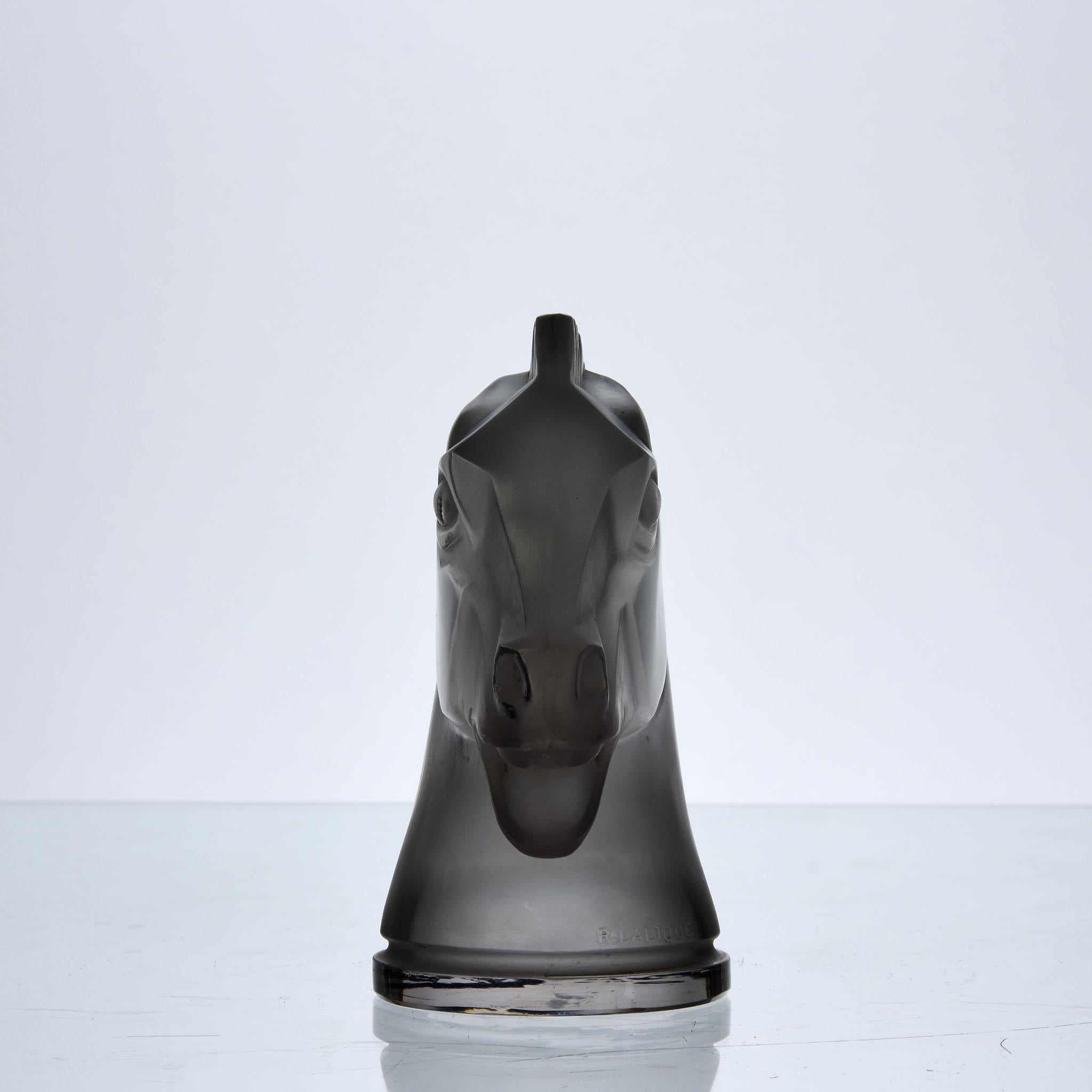 Impressive early 20th century French Art Deco clear and frosted glass car mascot modelled as a horse's head. This model was introduced as an acknowledgement to the popular French racecourse. Signed R Lalique and France

Longchamp
Catalogue