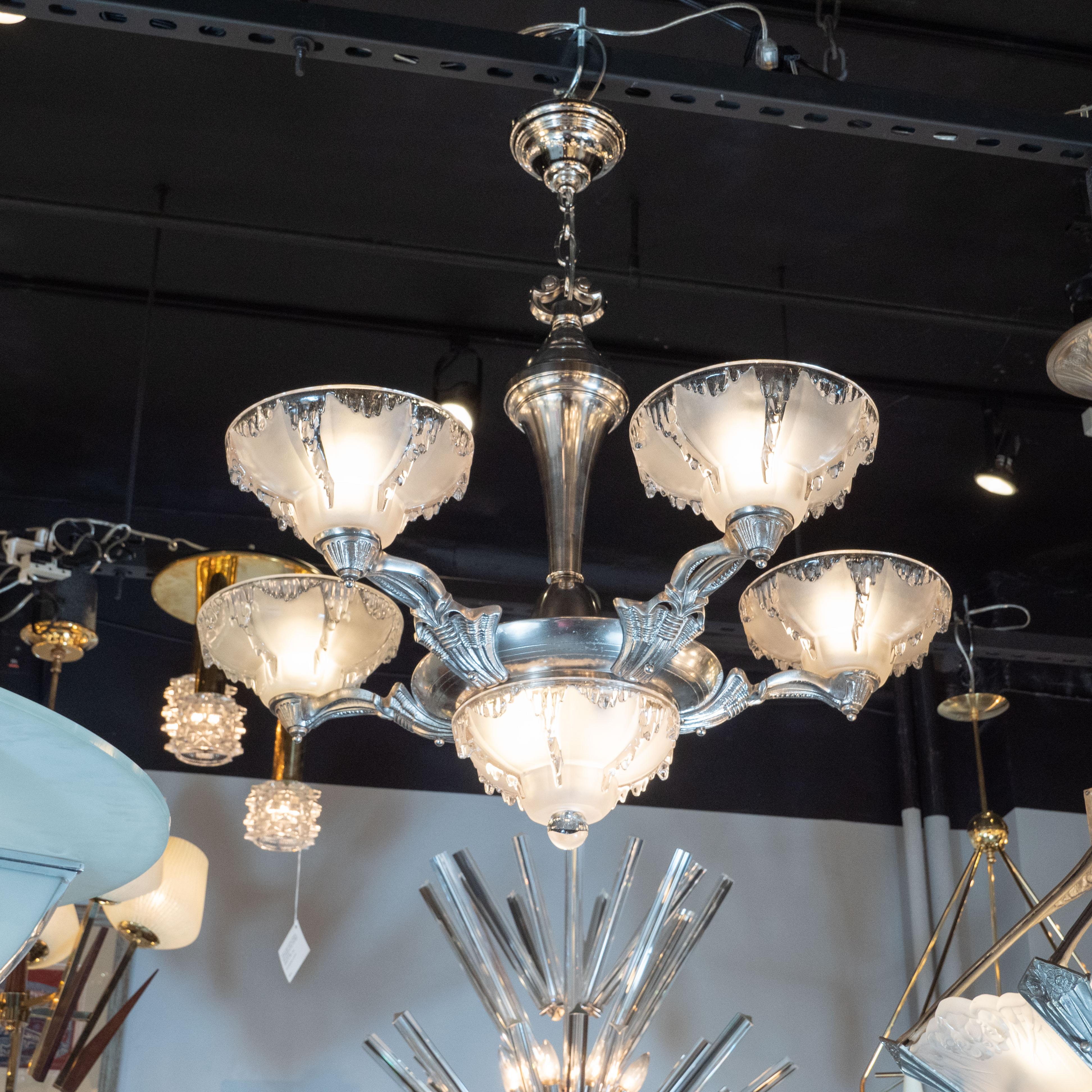 This glamorous and dramatic Art Deco five-arm chandelier was realized by the esteemed maker Ezan & Petitot in France, circa 1930. It features curved sculptural arms with abstract and geometric detailing that connect to a circular body all in