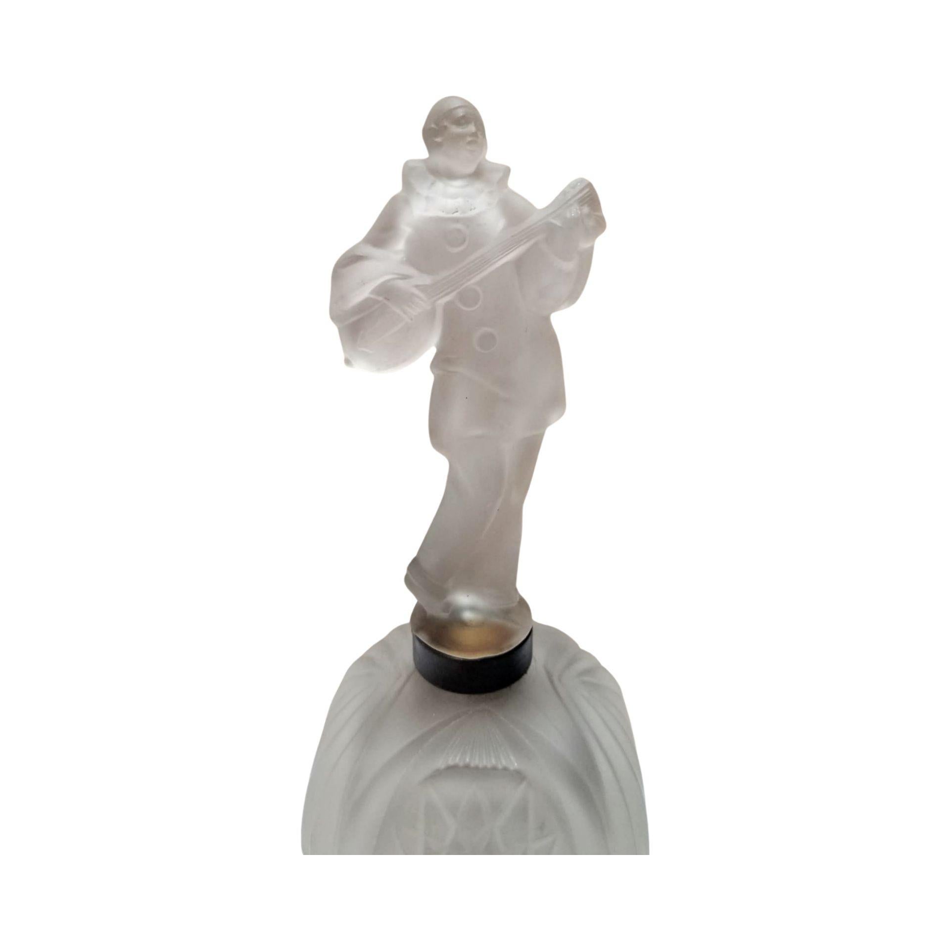 Art Deco lamp statue of a frosted glass jester with illuminating base
This Art Deco frosted glass lamp features a unique design of a jester playing a musical instrument. When illuminated, the lamp emits a soft warm light at its base, and unlit this