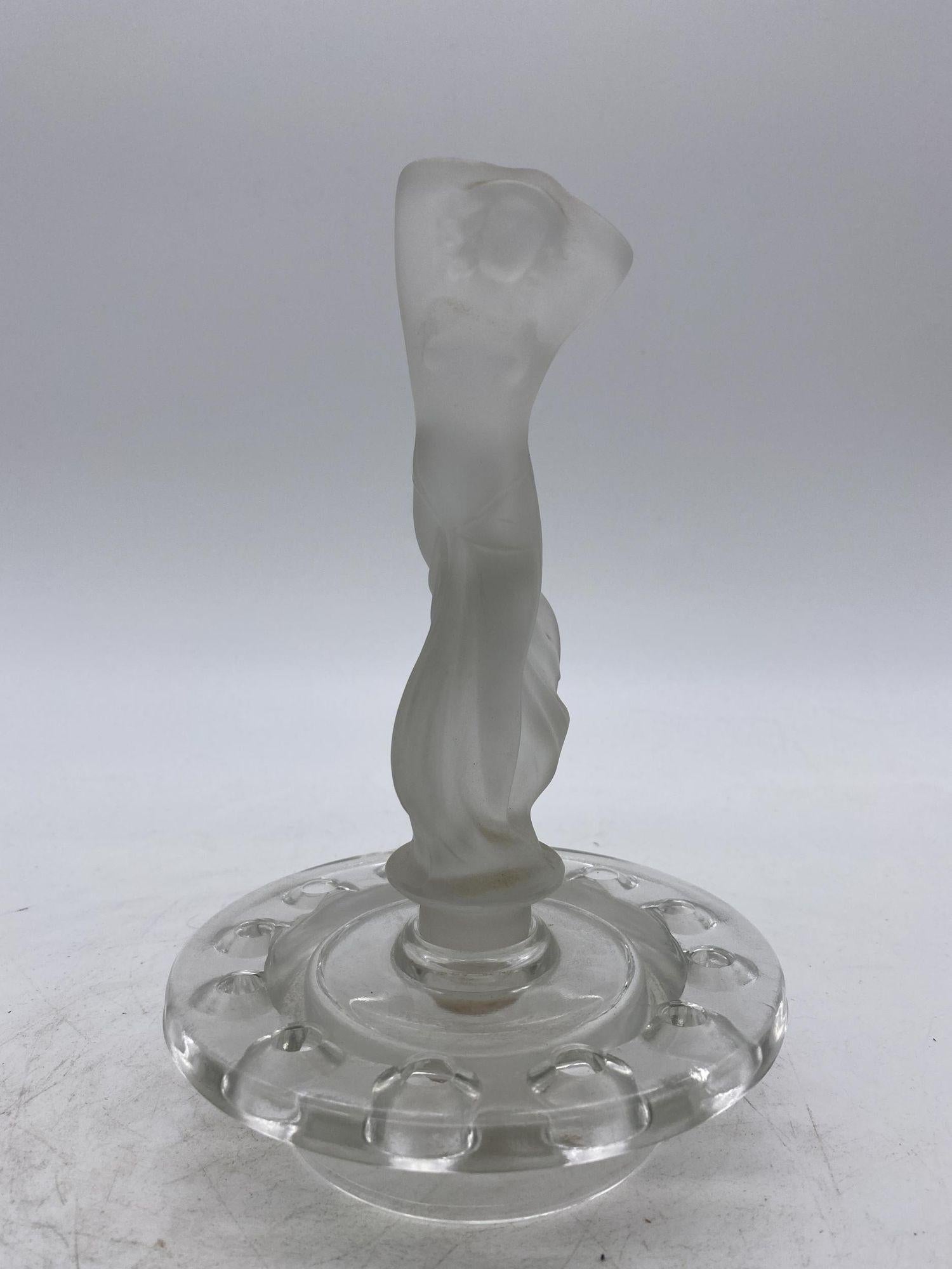 Art Deco frosted Art Glass nude Flapper flower frog featuring a beautiful topless female with a transparent leaded glass base featuring a dozen glass holes to hold one dozen flowers. 
 
Unsigned, 1930.