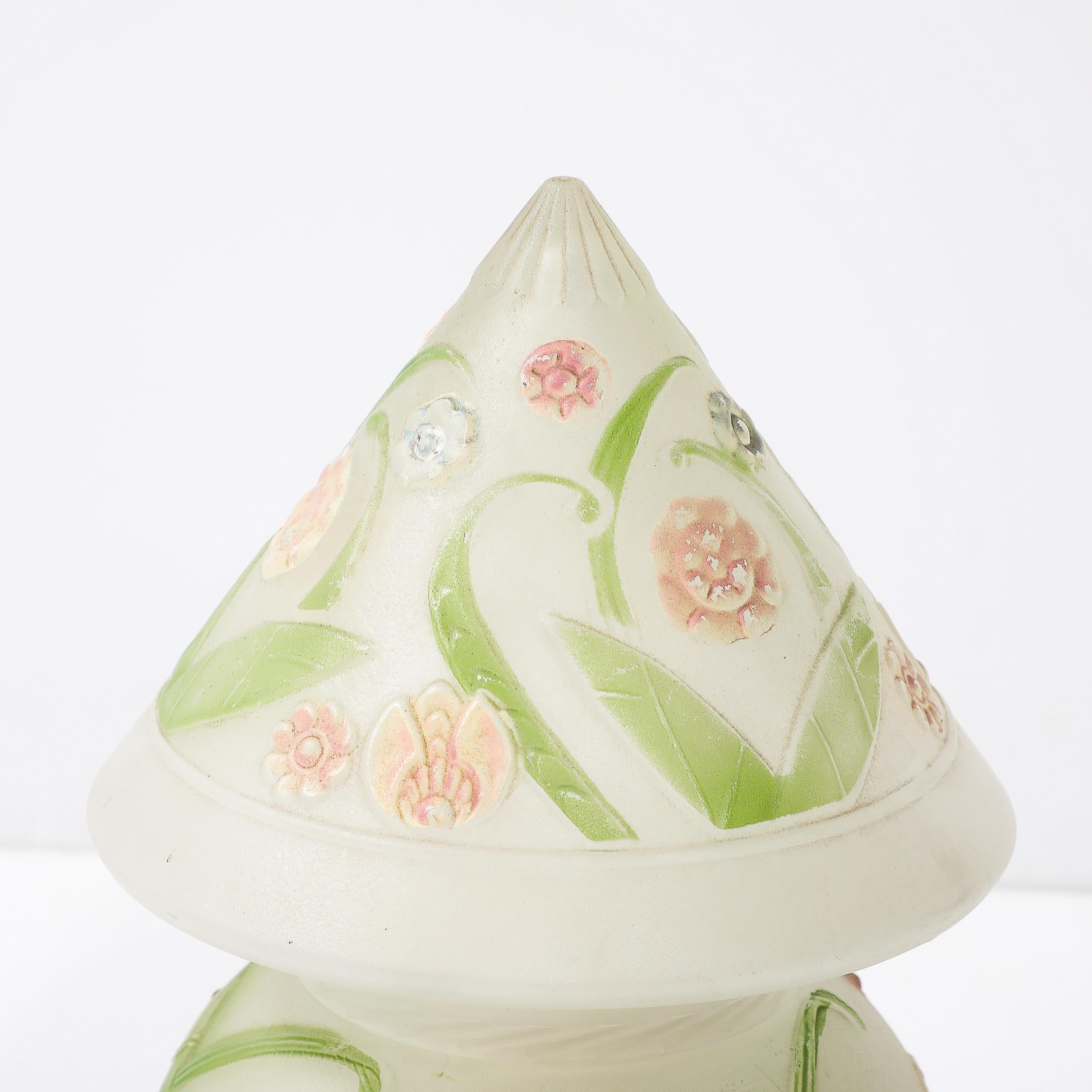 This delightful Art Deco Frosted Glass Table Lamp W/ Hand-Painted Floral Motif originates from the United States, Circa 1930. Features an upward pointing conical shade with a rounded body to the lamp, all in frosted glass with relief detailing.