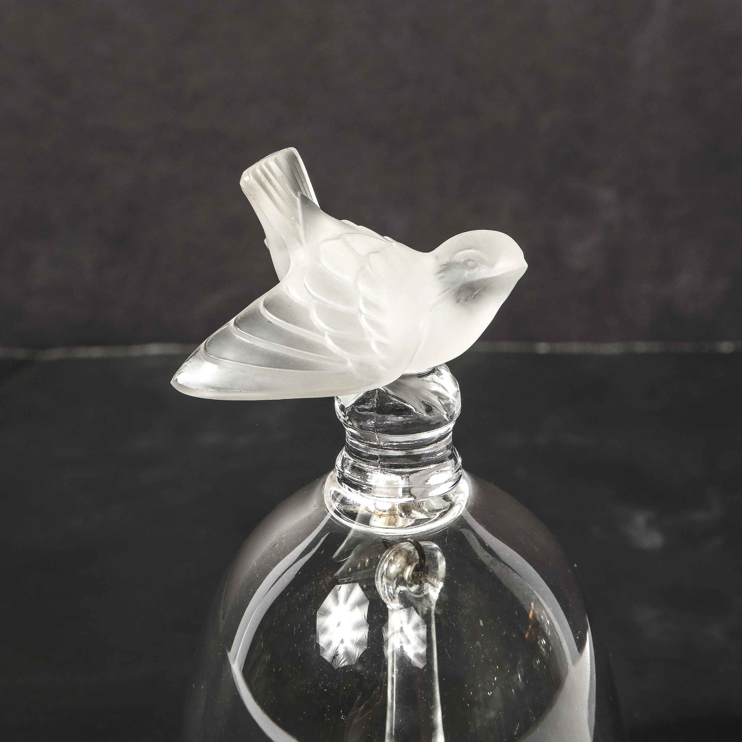 This charming glass bell originates from France, Circa 1925. The handle is in frosted glass and takes the form of a small bird. The sparrow appears to have just briefly landed on a lone bell's handle and is seen glancing upwards quickly