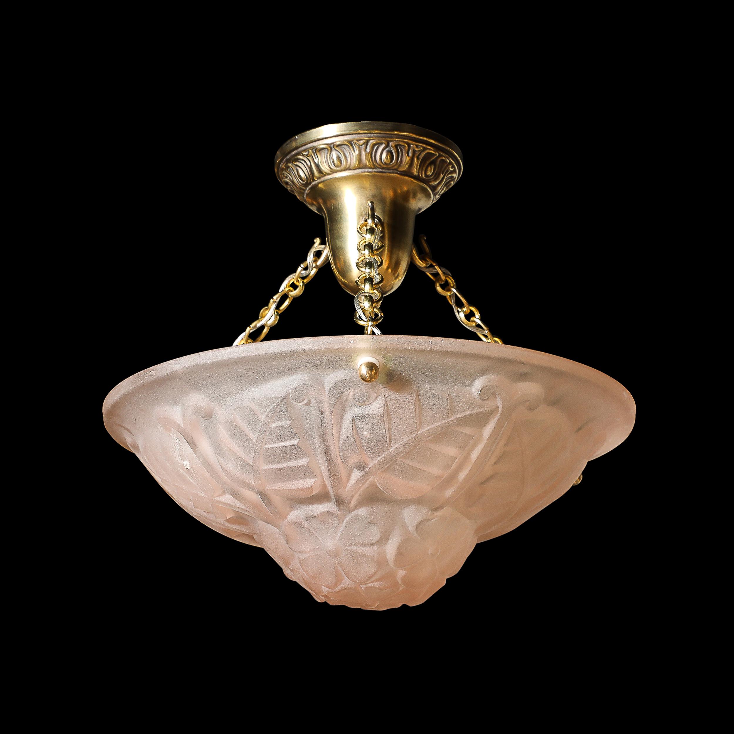 This subtle and elegantly formed Art Deco Frosted Rose Glass Pendant Chandelier Signed Degué originates from France, Circa 1930. Features a lovely round shade in a hue of lightly smoked rose with molded flowers and plants rendered in a minimal