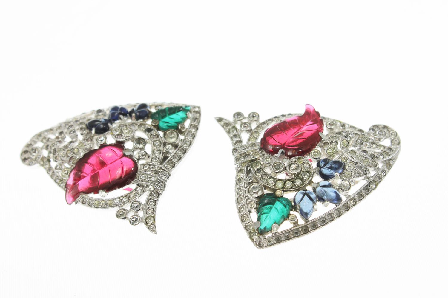 Influenced by Cartier's Art Deco Tutti Frutti era, these rhodium-plated white metal costume dress clips are also from this era and are commonly referred to as a fruit salad duette. Featuring glass poured and molded leaves and clear rhinestones. They