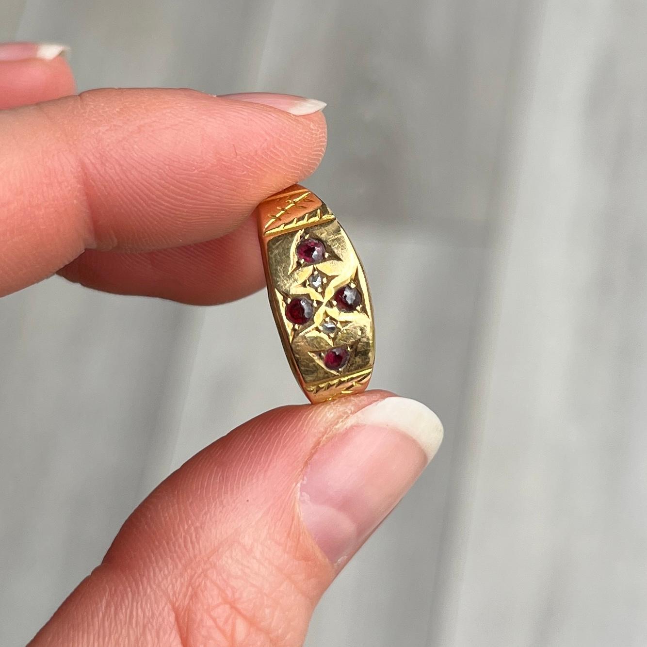 This stunning 18 carat gold band holds a total of four garnets and two rose cut diamonds. Each garnet is a deep red colour but has a bright red glow in the light and measure 7pts. Hallmarked Birmingham 1905.

Ring Size: O or 7 1/4 
Band Width: 8mm