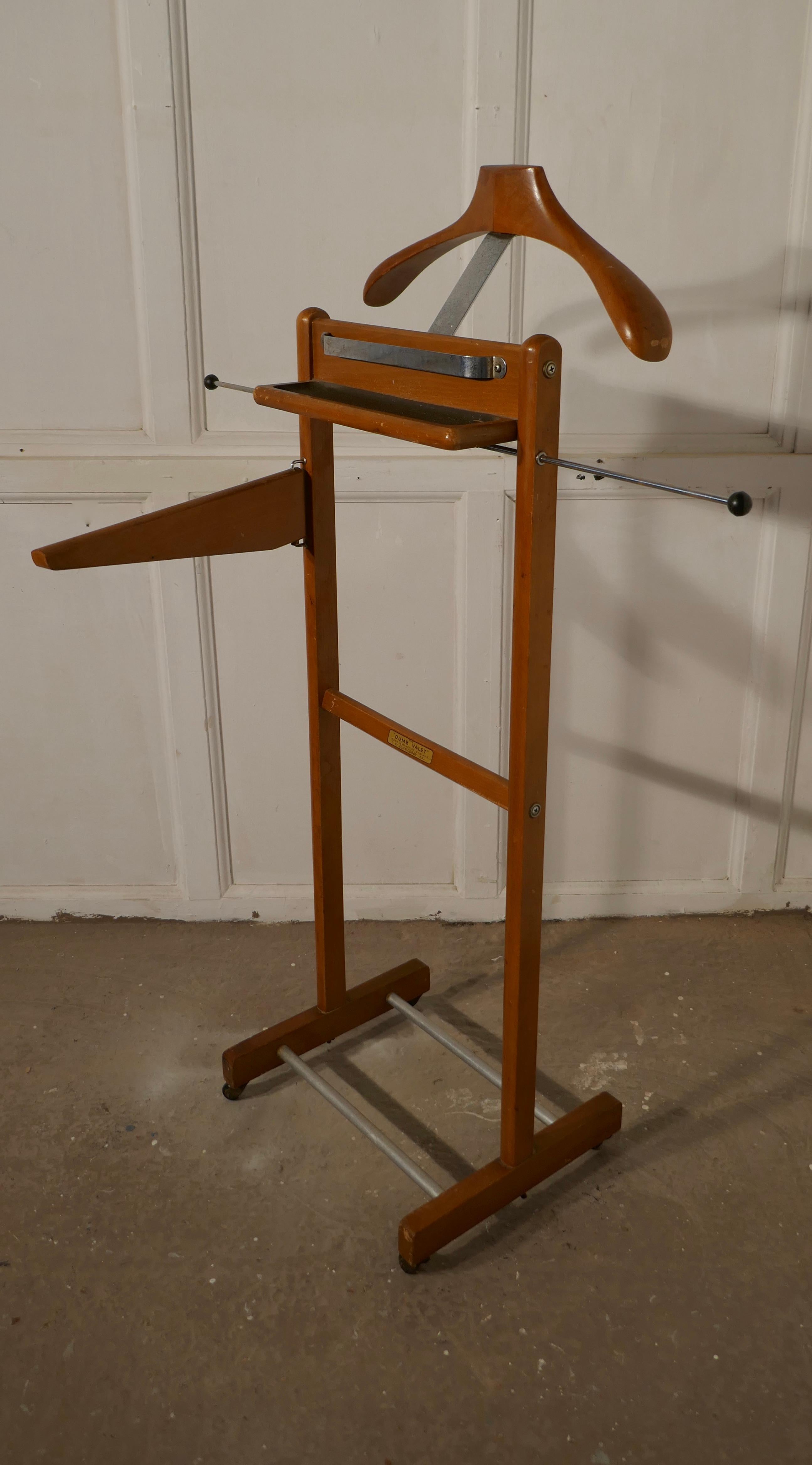 Art Deco Gentleman’s suit hanger or nightstand, the Versatile valet, by Corby of Windsor

A very useful piece, the hanger or clothes stand is made in golden oak, it has a hanger and will accommodate not only jacket it also has a rails for