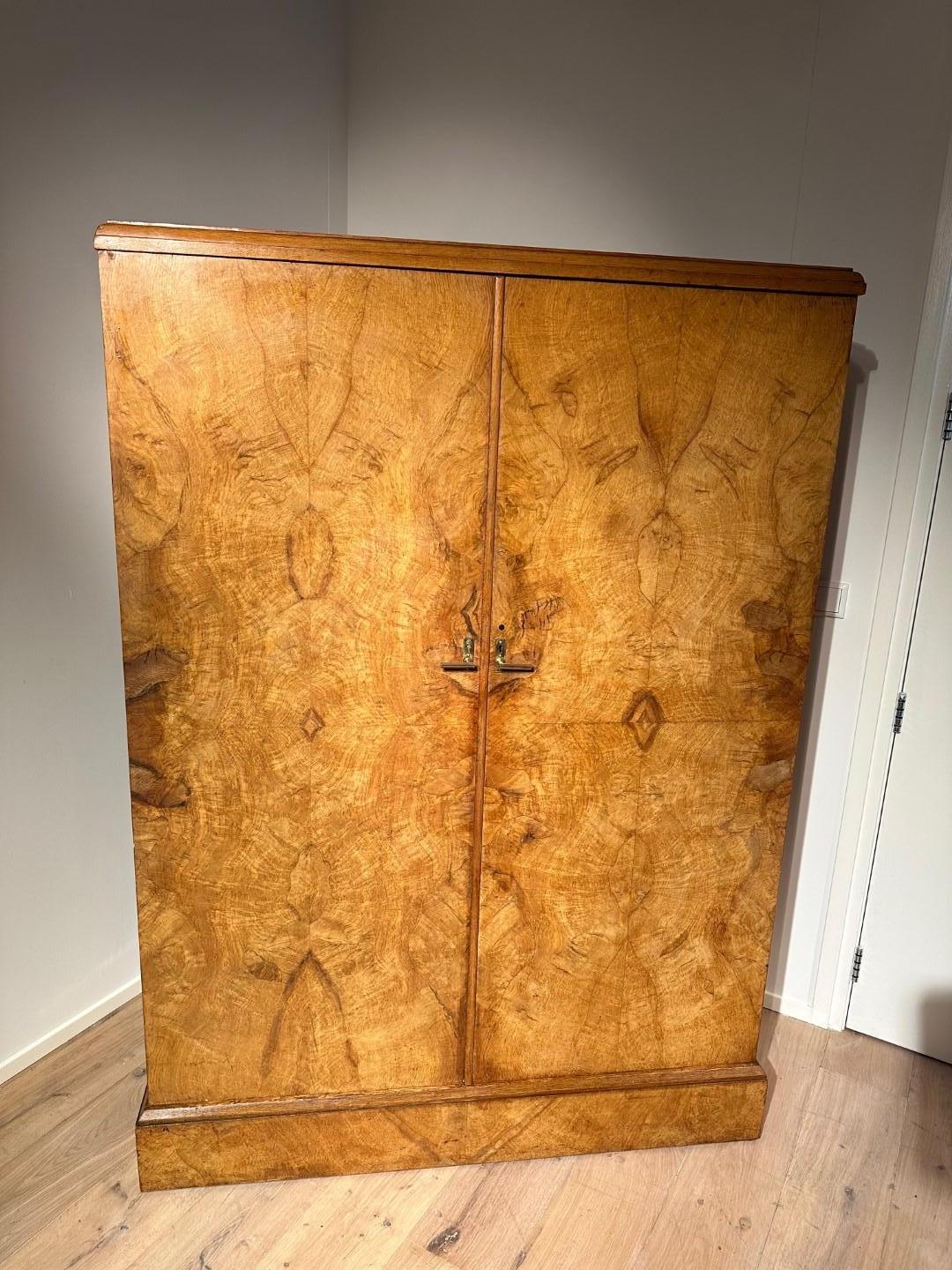 Compactom wardrobe with the beautiful interior where there is a place for every piece of clothing. The outside of the cabinet is finished with walnut wood, which is beautifully laid out in pattern. Nice light color. The inside is equipped with