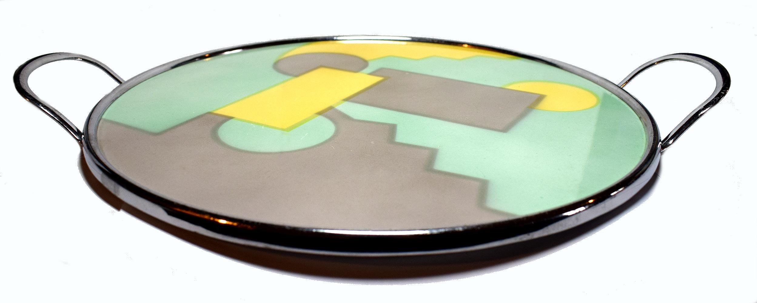 Very striking 1930s Art Deco glazed ceramic tray with chrome handles. Sourced in Germany and made in the Bauhaus and Spritzdekor era. Possibly by Th.Paetsch. Crafted with classic airbrushed geometric motifs in burnt soft pink, green, and daffodil