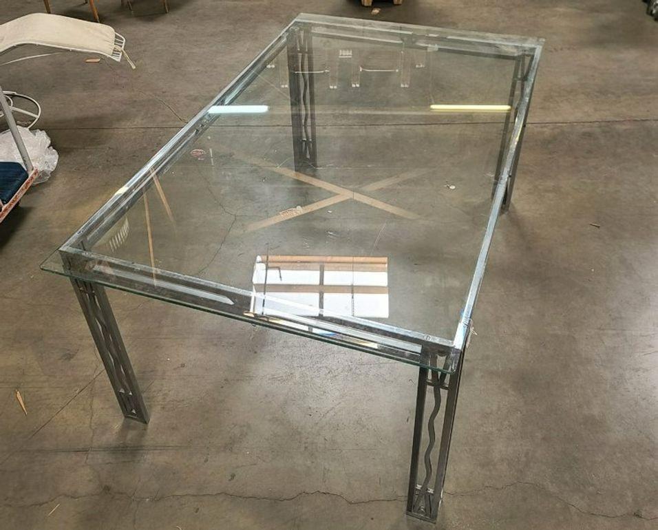 Beautiful vintage chromed bronze Art Deco dining table or desk. Includes glass top. Good structural condition with some scuffs/marks - see photos for details. We can restore this piece to original bronze under the chrome if desired.

The table's