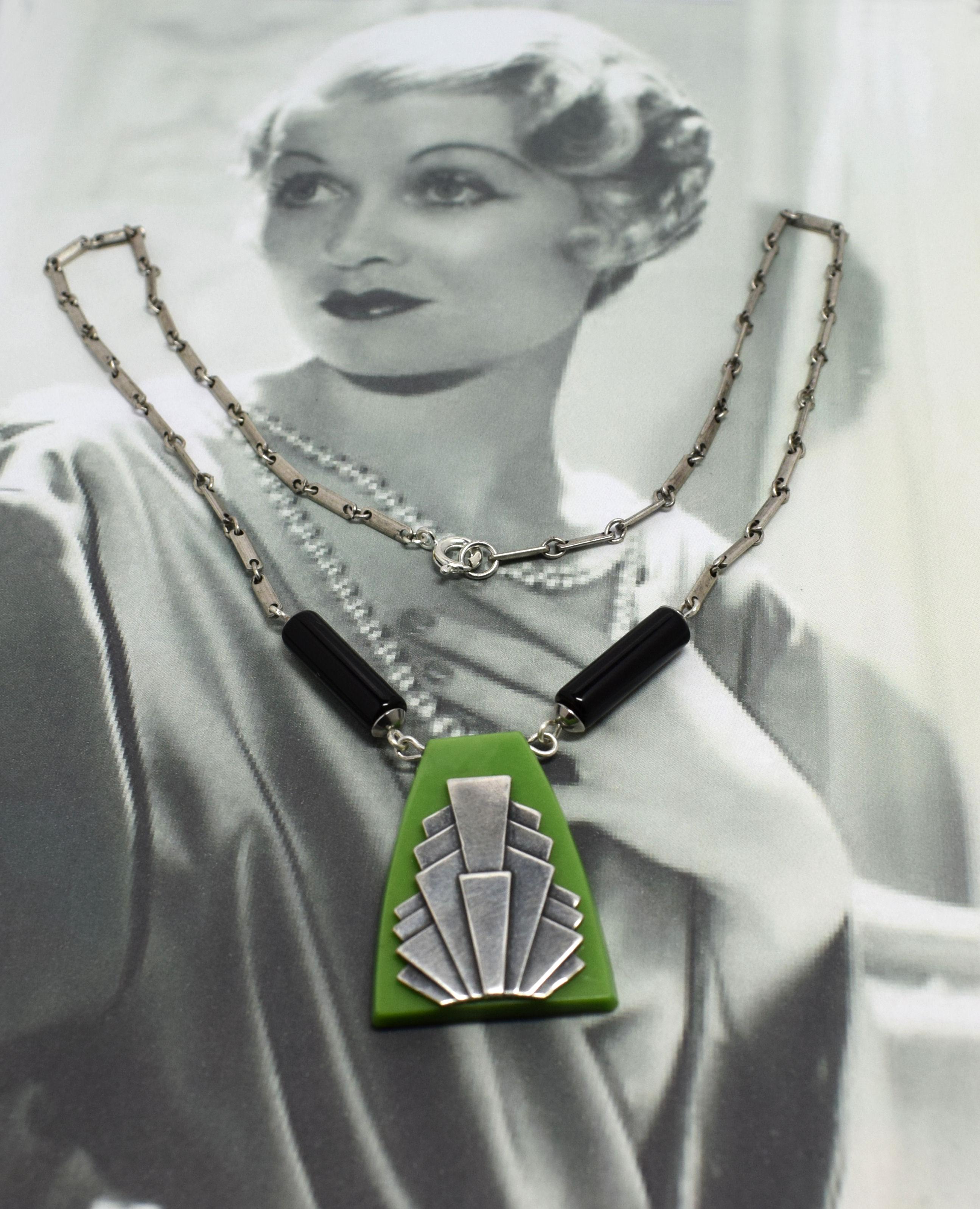 Stunning Art Deco geometric necklace made from green galalith and black lucite. Wonderful fan shape accent in chromed metal to the center of the bakelite, really iconic and can't be mistaken for any other era. As one of the leading manufacturers of