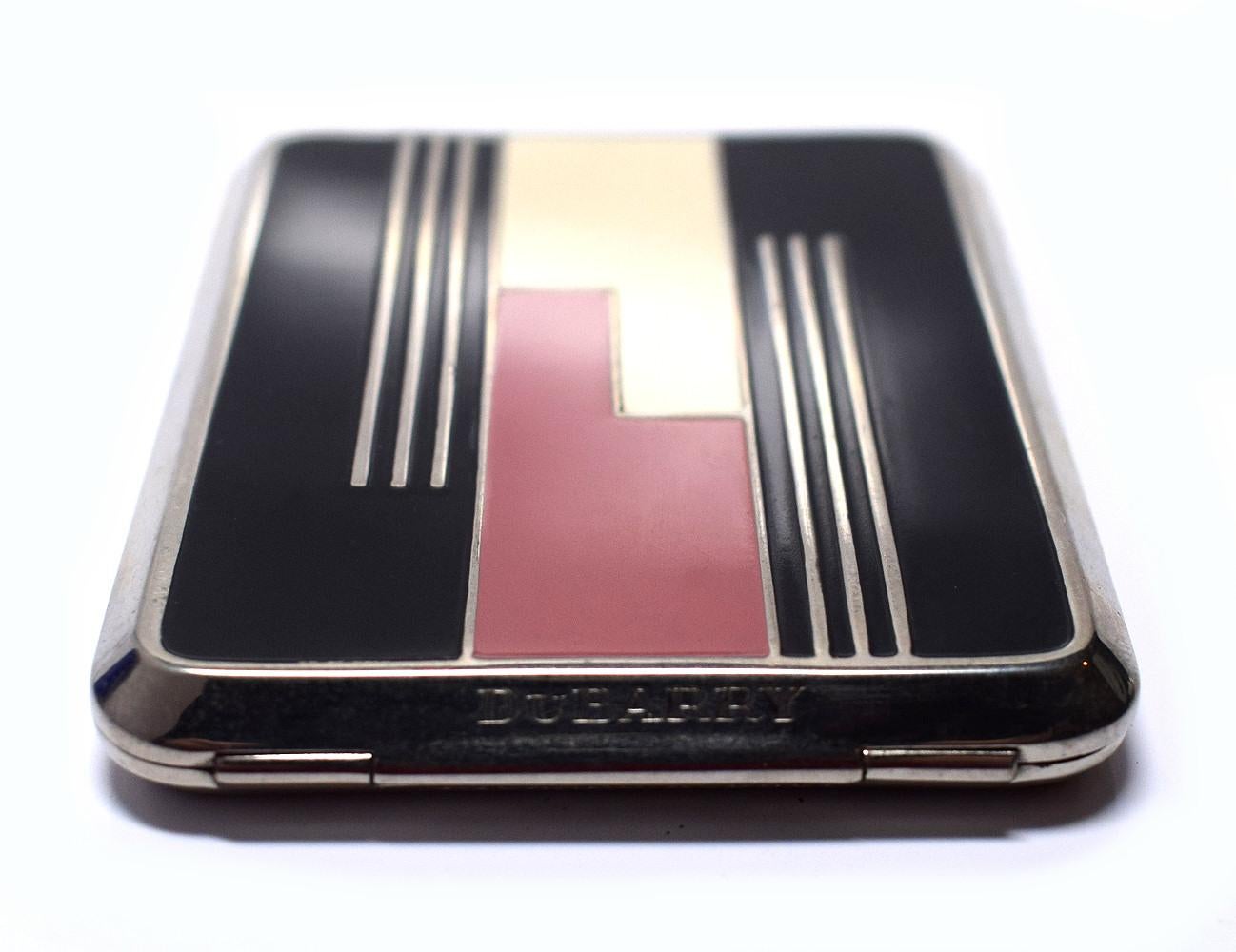 Early 1930's Art Deco Richard Hudnut Du Barry powder compact with remnants of the fine texture face powder in two-tones of bright red. Du Barry scent is still detectable despite the age of the powder. The back of the compact is engine turned with