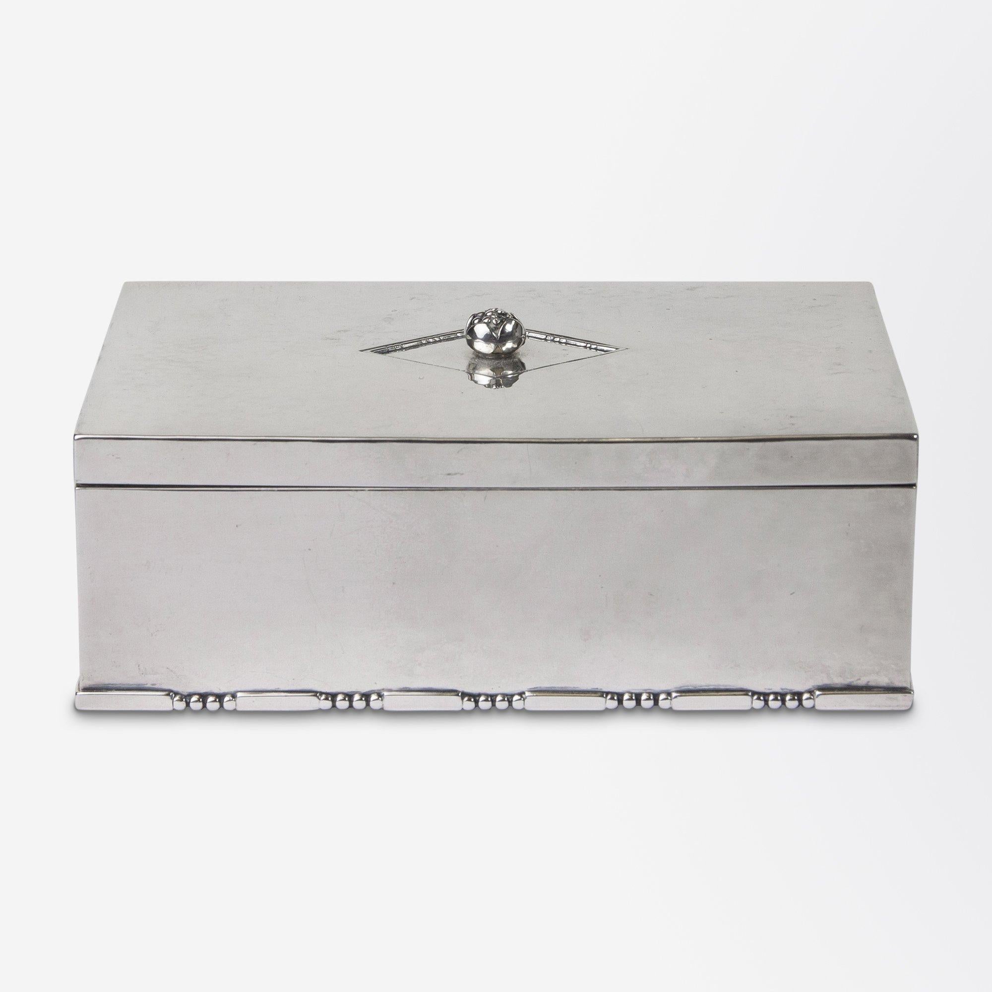 An exceptional Art Deco sterling silver cigarette or jewel box designed by Johan Rohde (1856-1935) for Georg Jensen. The silver box had a berry finial positioned to the centre of an incised lozenge and the bottom rim of the box has a part beaded